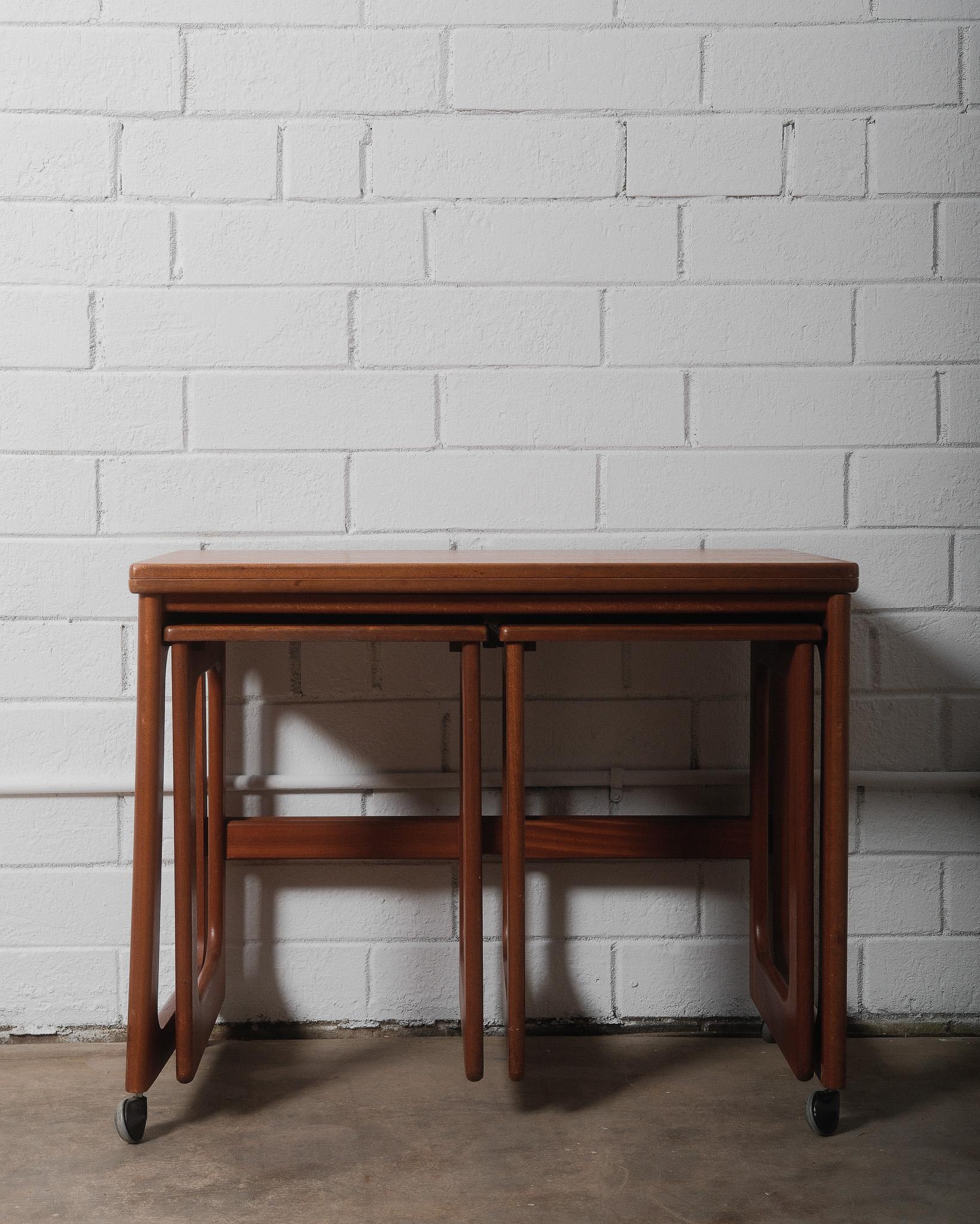 A beautifully designed and highly functional Mid-Century Modern nesting table set by A.H. McIntosh & Company, Scotland, a distinguished manufacturer known for its exceptional craftsmanship and timeless designs. Crafted during the mid-20th century,