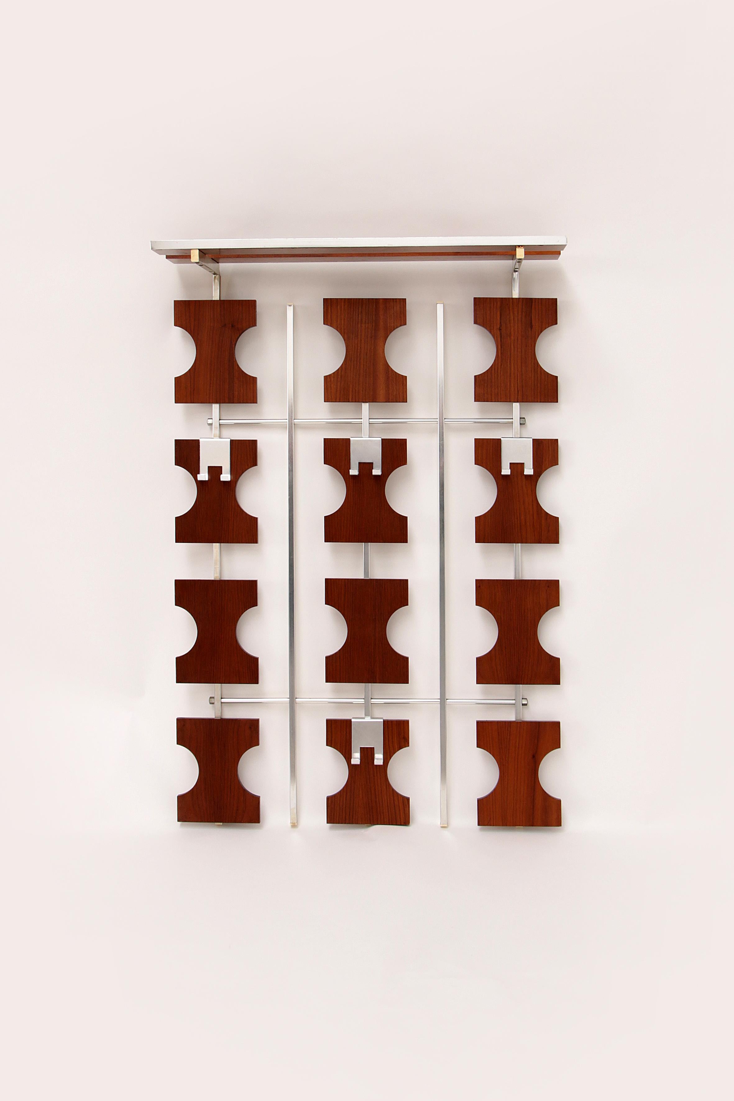 A beautiful example of sturdy and striking German design. This stylish wall coat rack will make a unique addition to any hallway.

Made of wood and metal with veneer.

The coat rack is made of wooden blocks with iron details that give it a