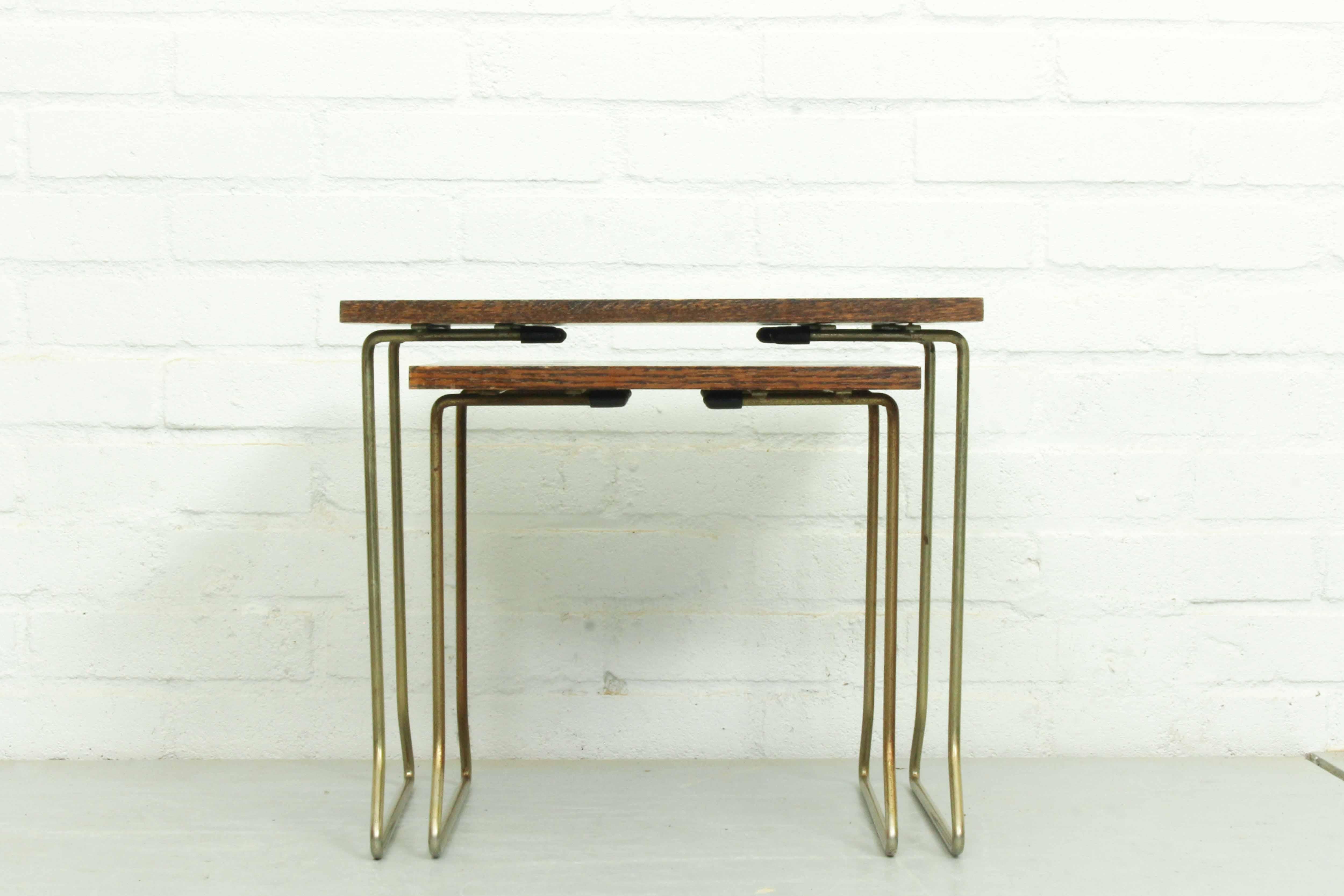 Quite rare set of two wood veneer and metal nesting tables by Brabantia. Some traces of use. 

Dimensions: 31cm H, 31cm W and 31cm D. and 34cm H, 39cm W and 31cm D.
  