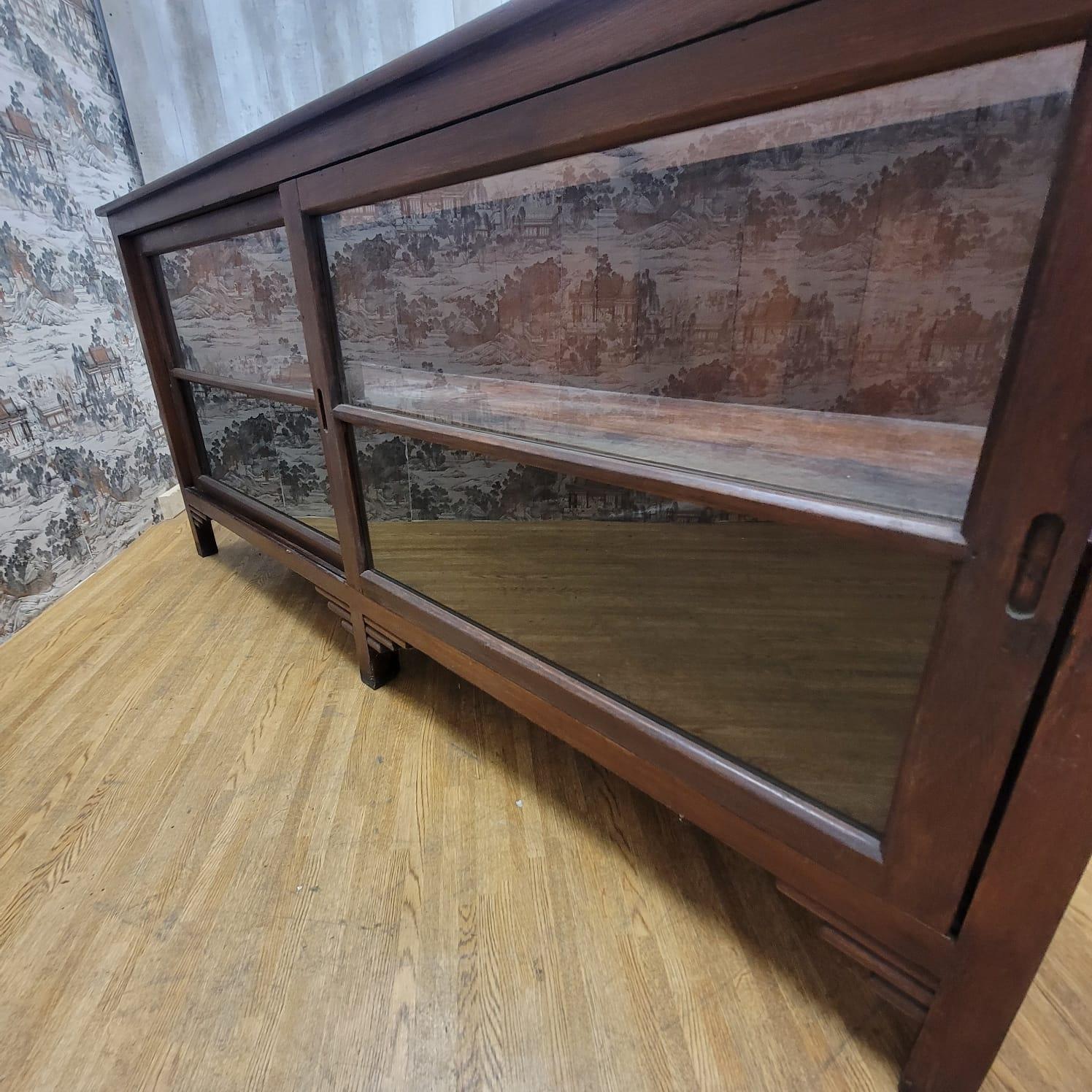 Vintage teakwood low bookcase / display cabinet with sliding glass doors

This vintage teak bookcase or display cabinet was handmade in North Carolina, USA. It has its original color and patina.

Circa: 1995

Dimensions:

W: 85