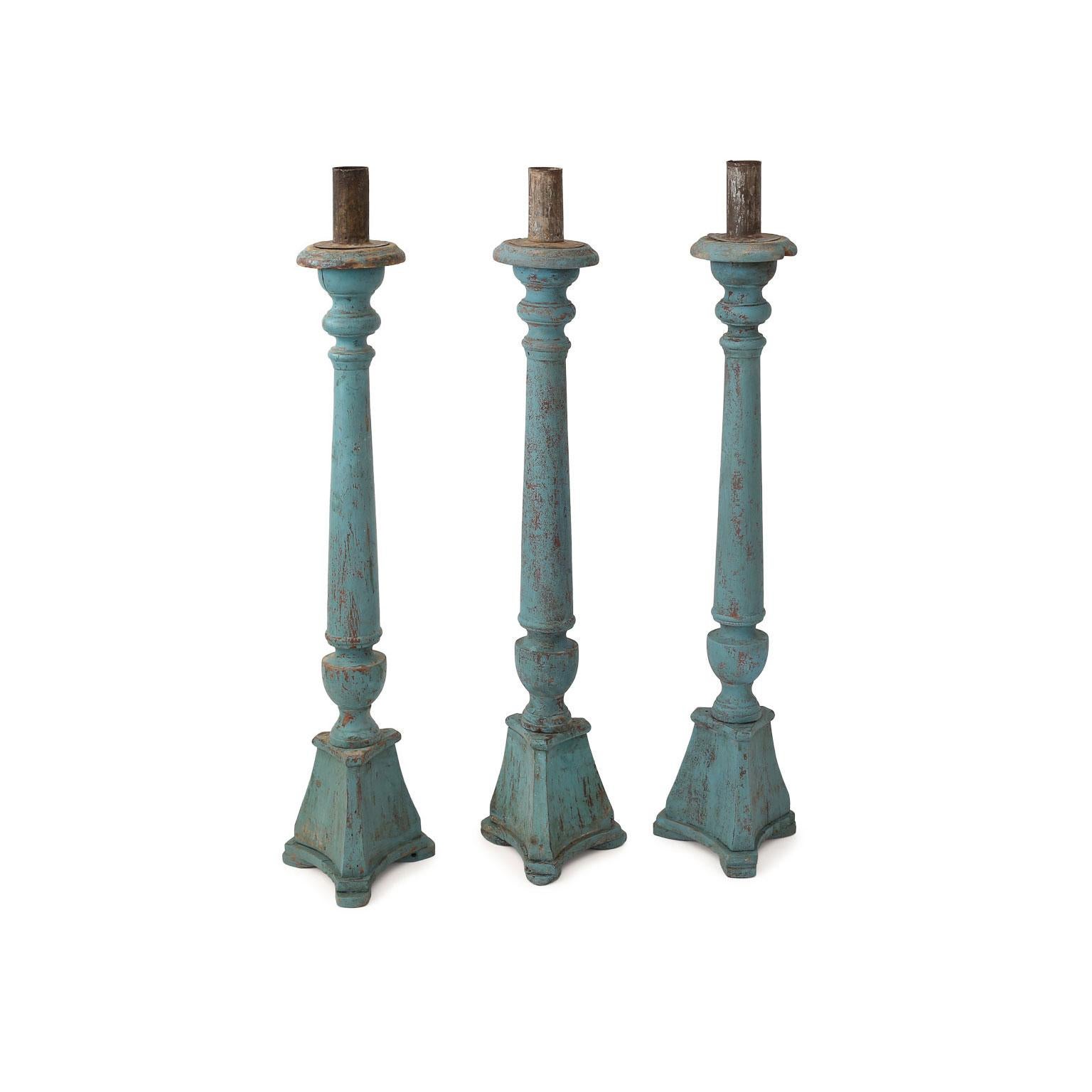 Vintage teal-blue painted candlestick, hand-carved from Spain. Topped with a tole candle-holder. Three available. Priced and sold individually $450 each. Height varies between 32 to 33.5 inches. Width 6.5 inches x Depth 6.5 inches.