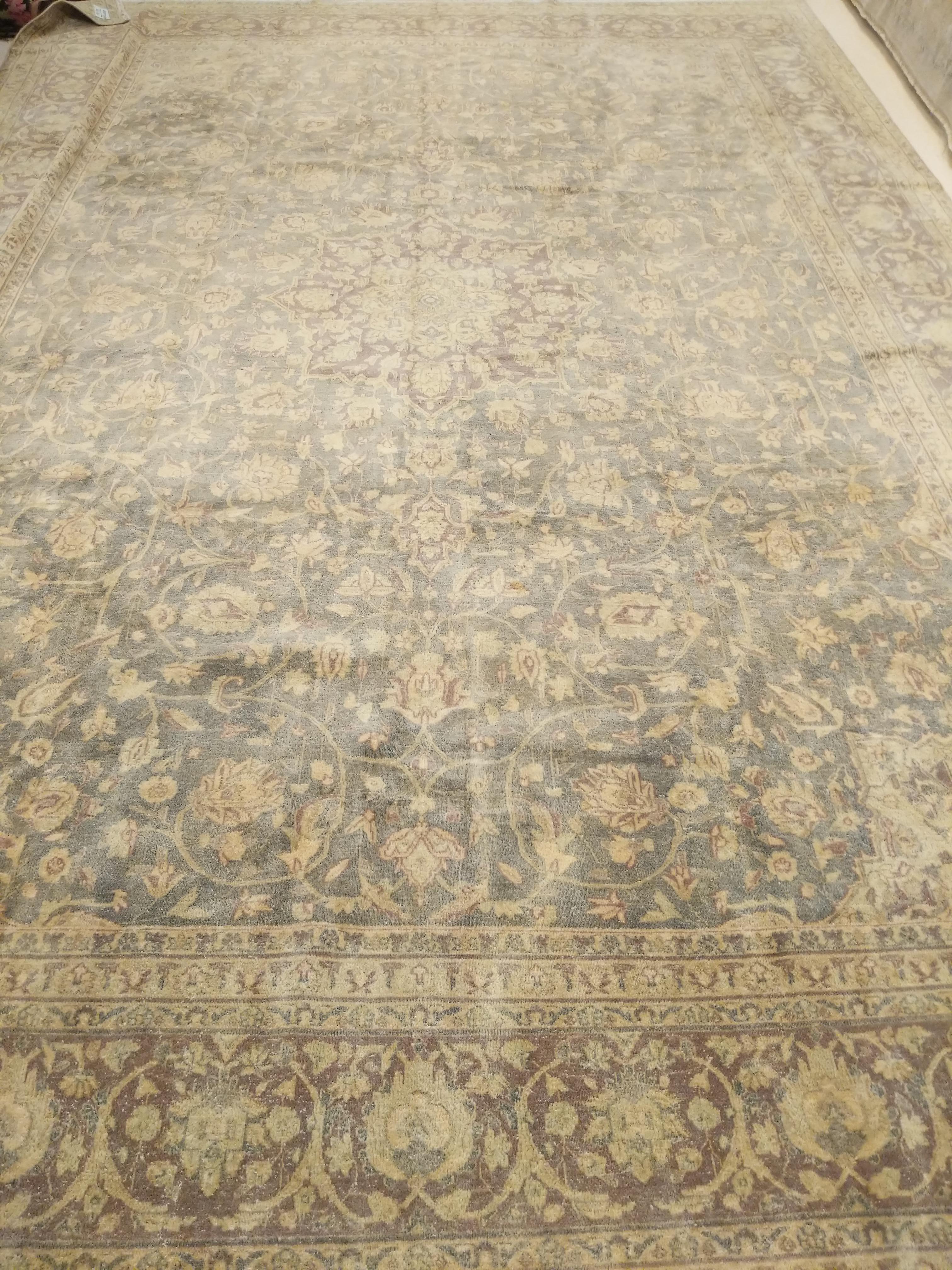A highly refined and sophisticated Sivas carpet, distinguished by an elegant teal color and framed by an arabesque border floating on a soft aubergine background. The delicately drawn small medallion is somewhat concealed in the field by the soft