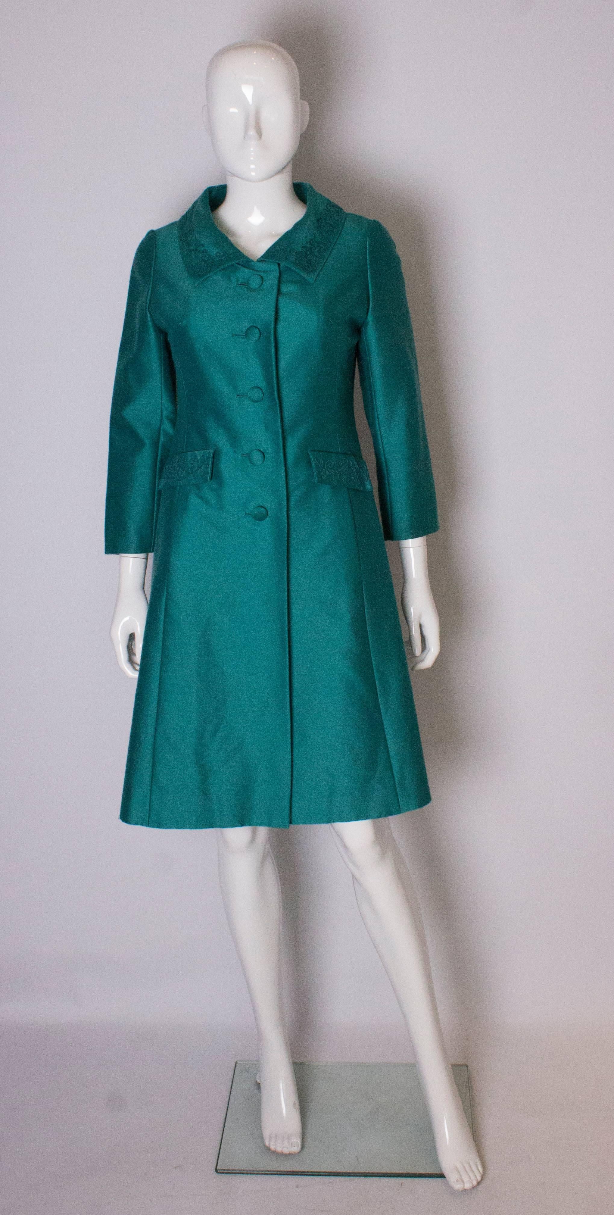 A chic coat for any season. The coat is a wonderful teal colour, in a wool mix with satin lining with detail on the collar and pockets. It is fully lined.