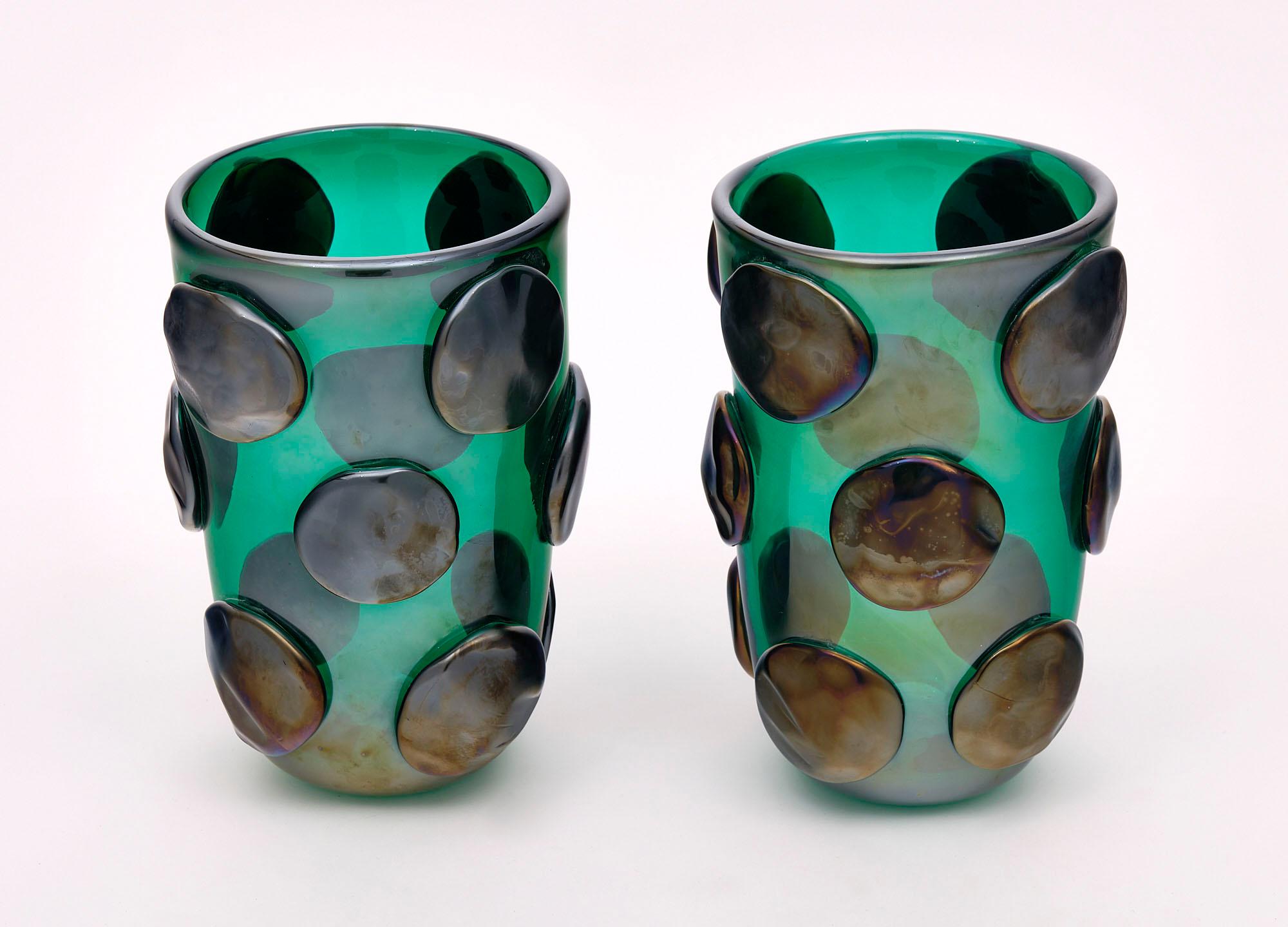 Pair of vases from the island of Murano featuring a deep teal green color with iridescent bronze medallions applied during the fusion process.