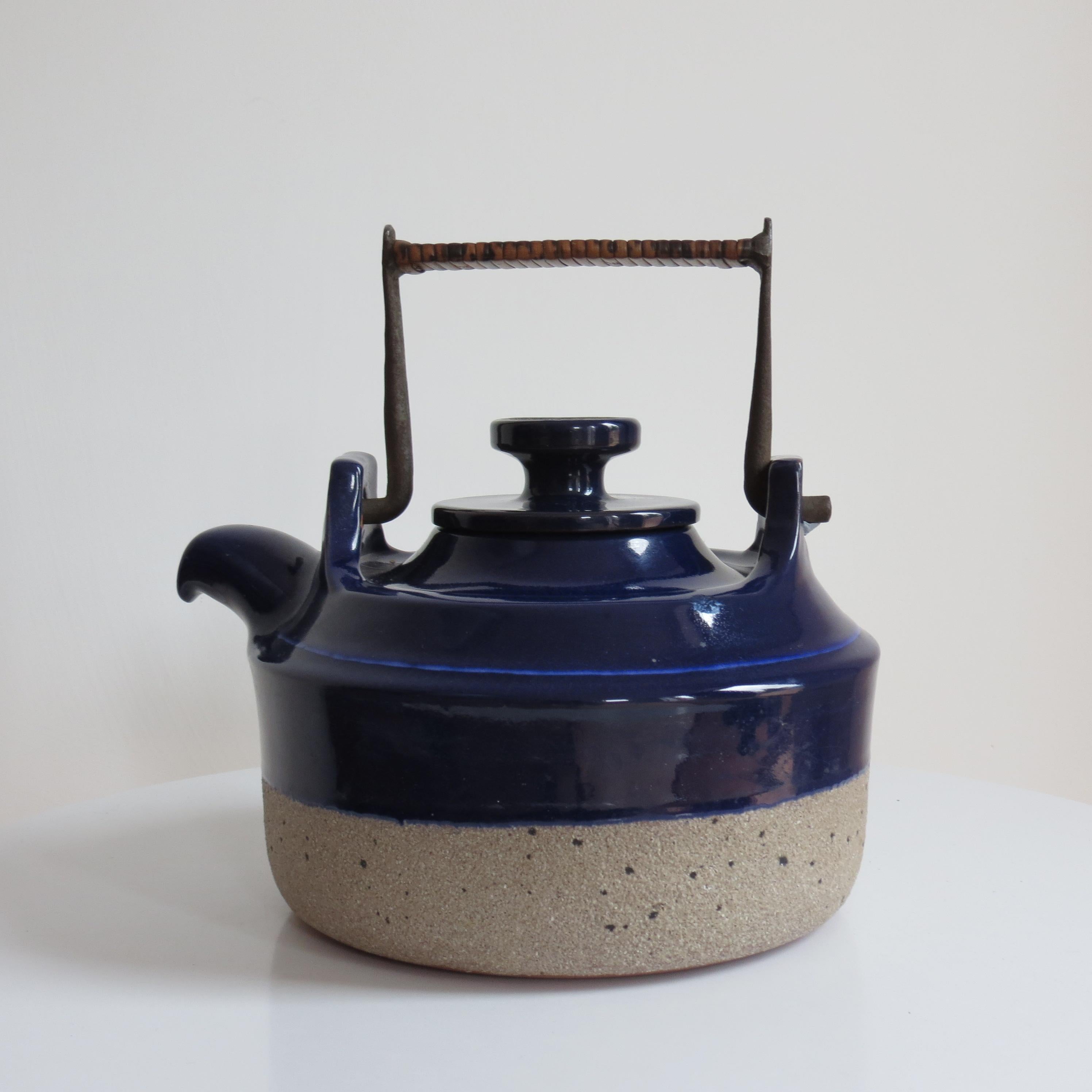 1960s Earthenware teapot, designed by Thomas Hellstrom for Nittsjo Sweden. Wonderful shaped, handmade earthenware and blue glaze teapot, formed steel handle decorated with rattan. The teapot is stamped to the underside and reads 