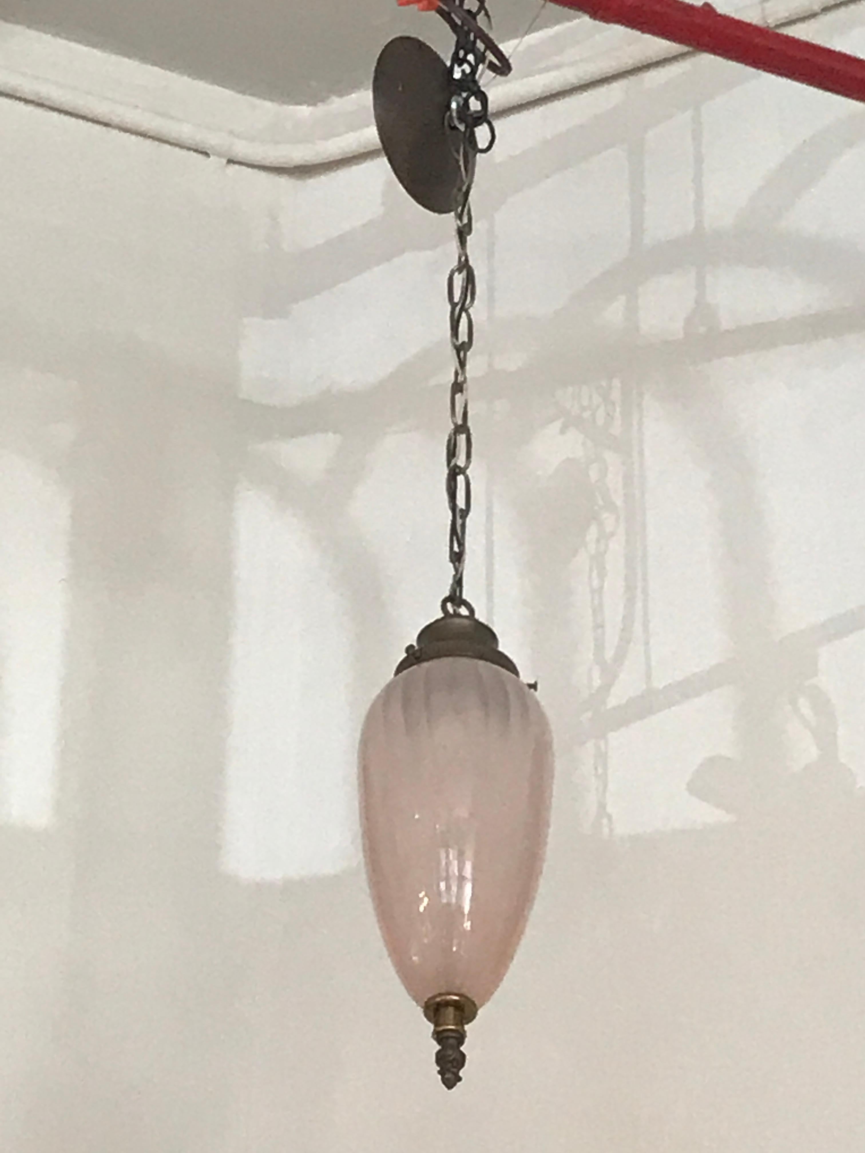 This elegantly vintage teardrop glass pendant brings a feminine touch with its pink hue milky glass. The subtle texture emphasis a timeless esthetic that would compliment many homes.

Measure: Overall length 37
