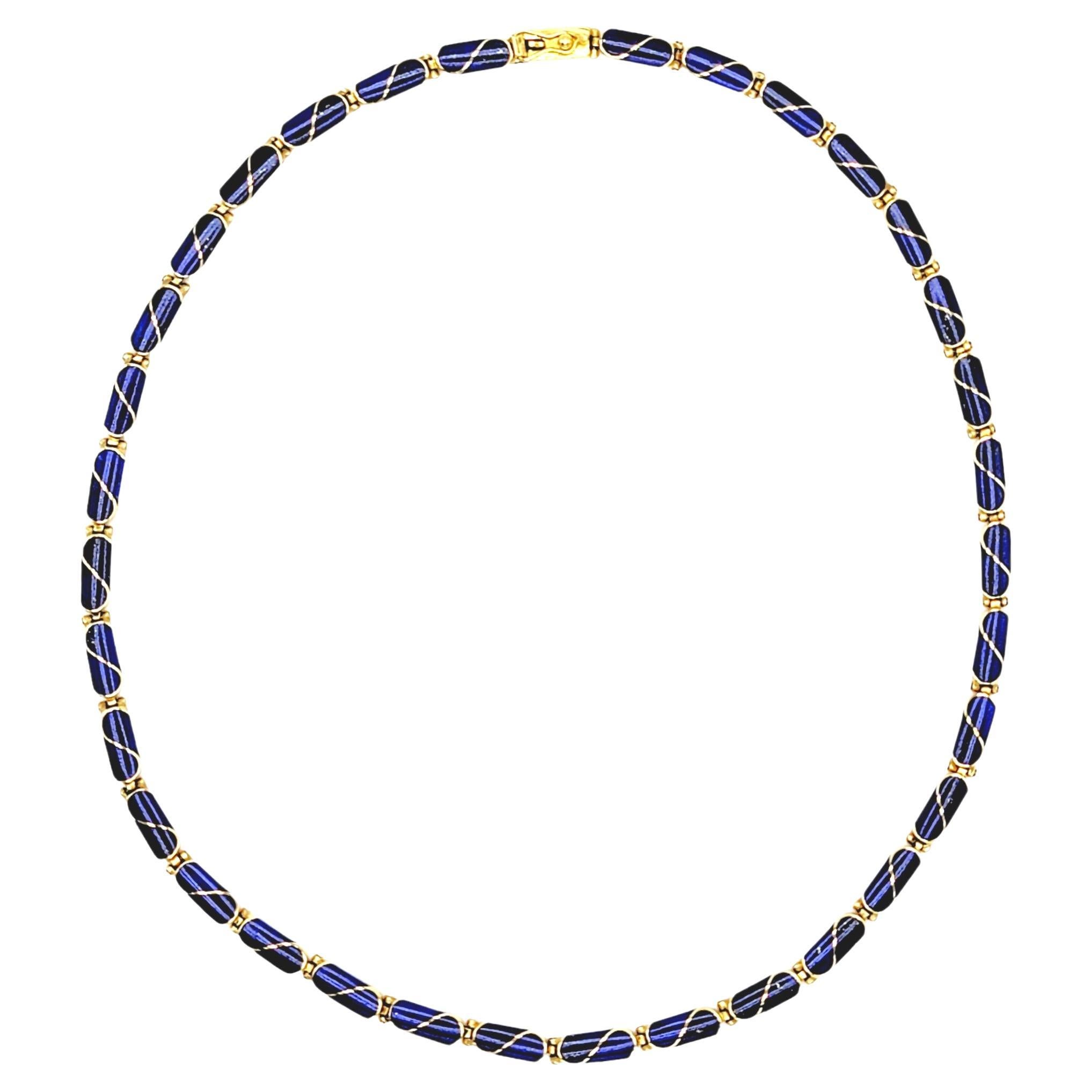 Brightly colored vintage choker style necklace is stunningly simple in design, but makes a bold statement. The deep blue lapis lazuli stones paired with the warm yellow gold makes for a striking contrast and looks beautiful on the neck. 

Necklace