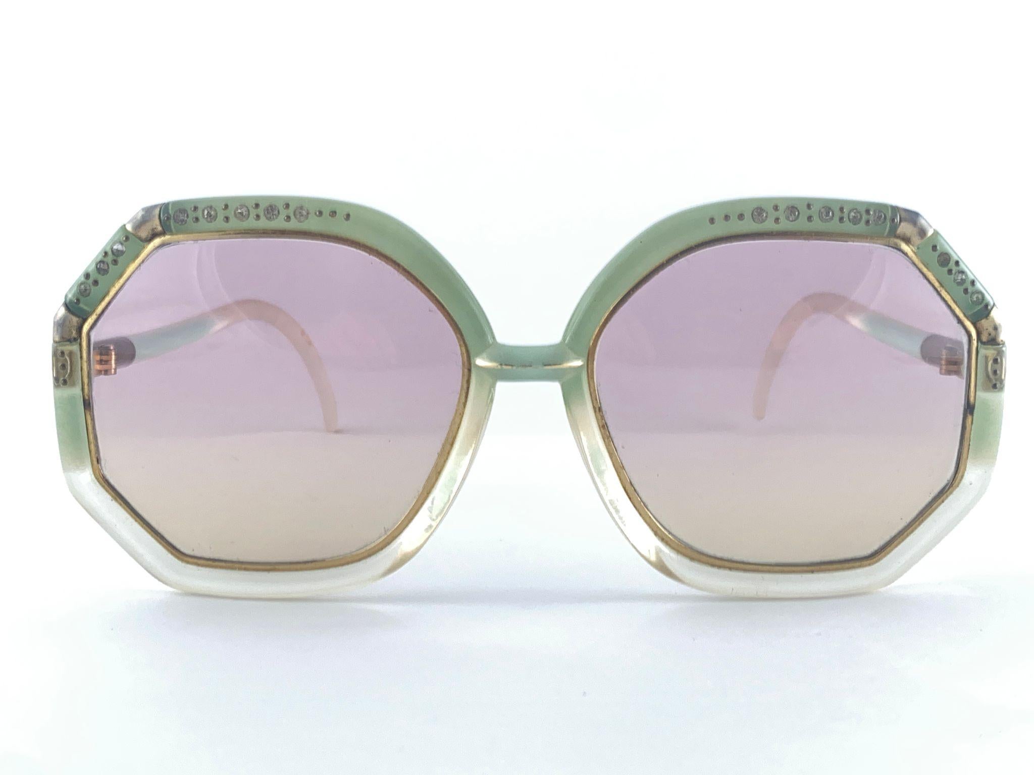 Vintage Ted Lapidus Gradient Green Adorned With Rhinestones Frame With Spotless Light Rose Lenses.  
Made In Paris.  
Produced And Design In 1970'S.  


Measurements 

Front : 15 Cms 
Height : 5 Cms
Width : 5.5 Cms

