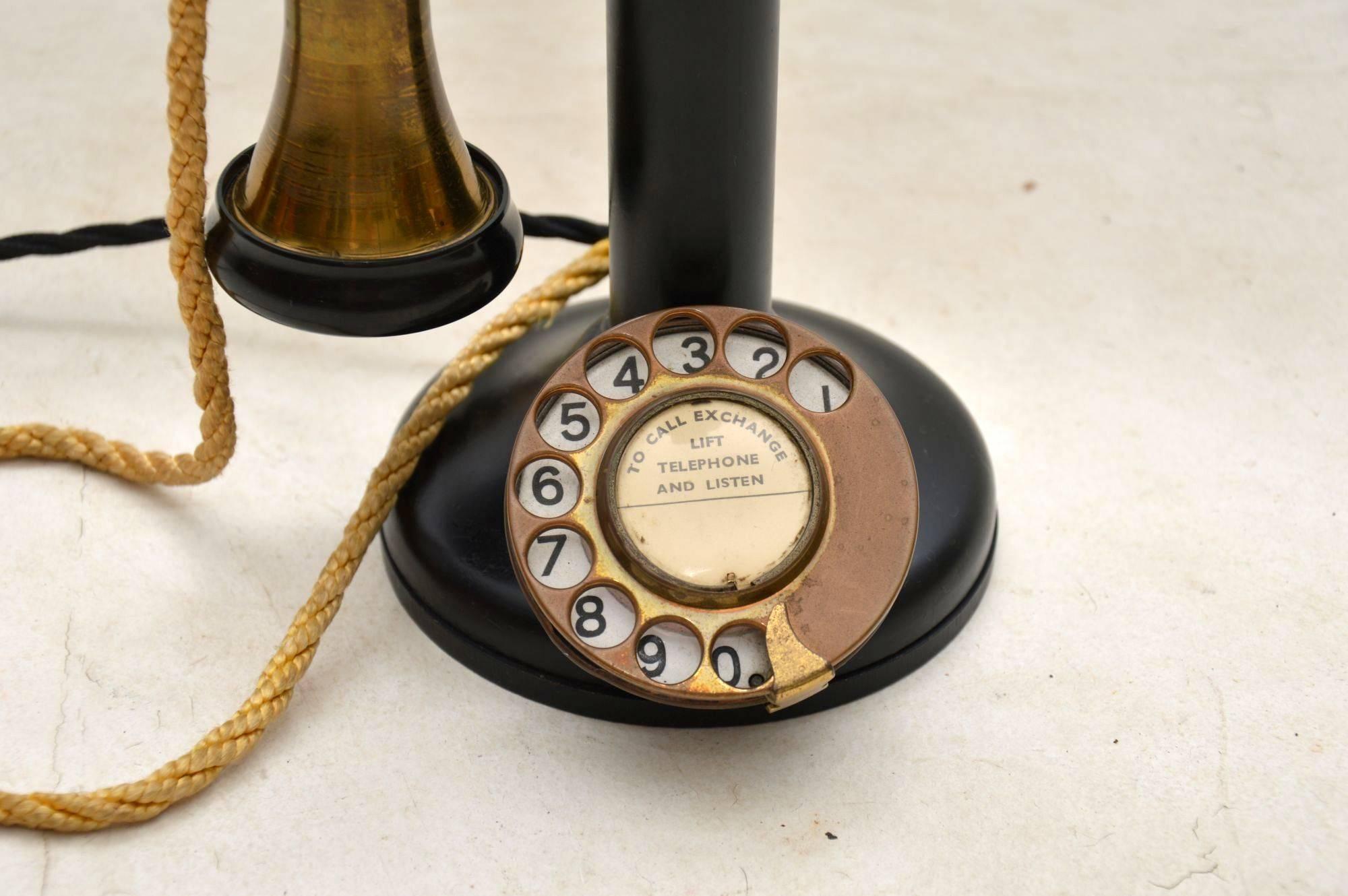 A charming vintage lamp, this is an antique telephone with a built in lamp. The telephone is probably from the early 20th century, it might have been adapted to have the lamp on, but it actually looks original to me. The socket and shade are set at