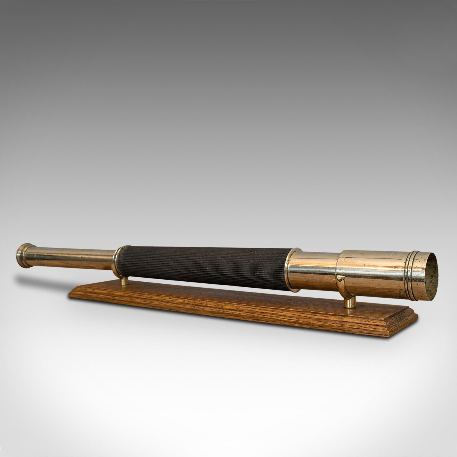 This is a vintage telescope. An English, brass 'officer of the watch' single draw refractor by Ross of London, dating to the mid-20th century, circa 1935.

Perfect for bird watching, landscape appreciation, wildlife, or maritime observation.