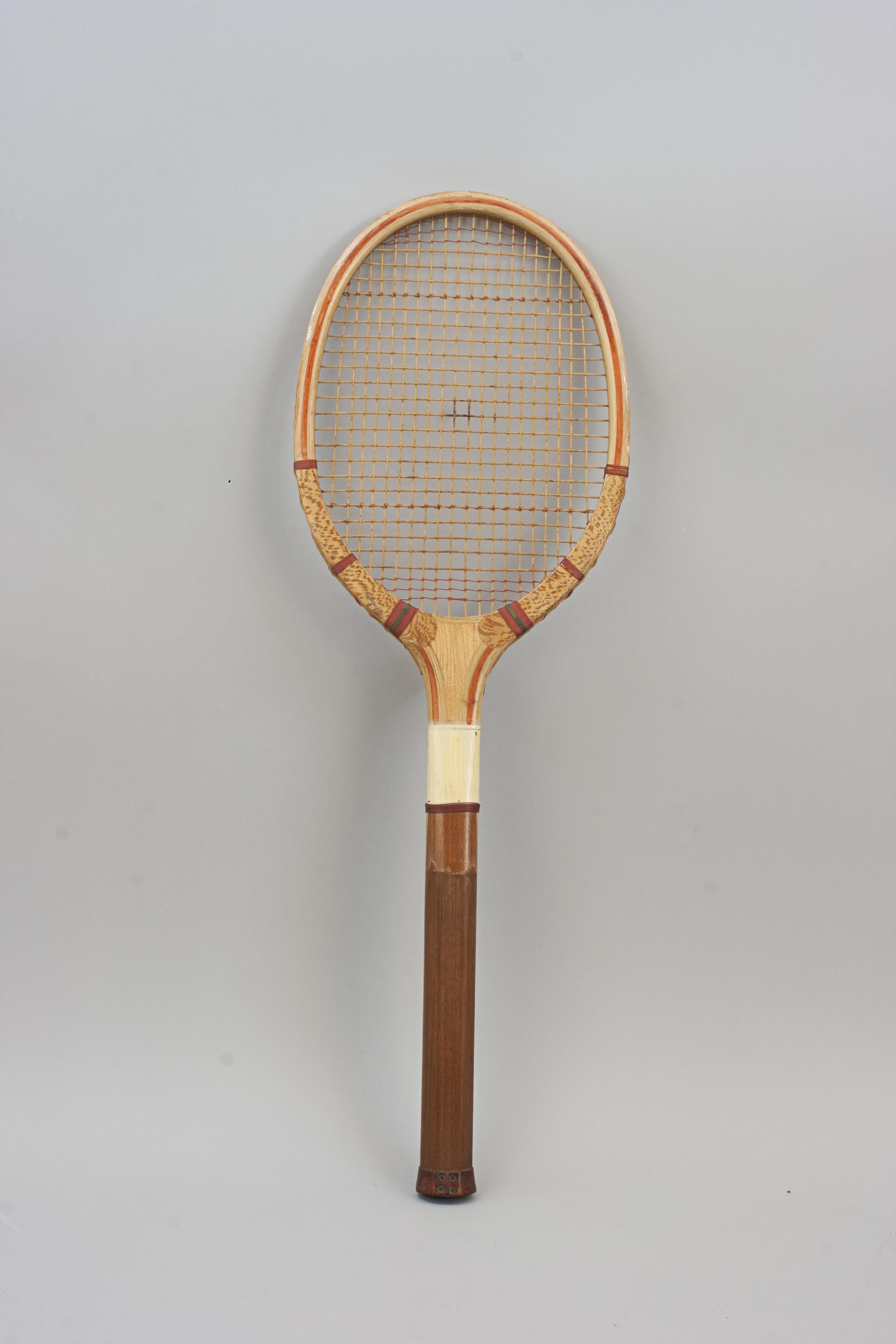 The True Bat Lawn Tennis Racket.
A lawn tennis racket by unknown maker, 'The True Bat'. A nice ash laminated frame with concave wedge. The wedge with decal 'The True Bat' with an image of a flying bat. The racket has the original red shoulder