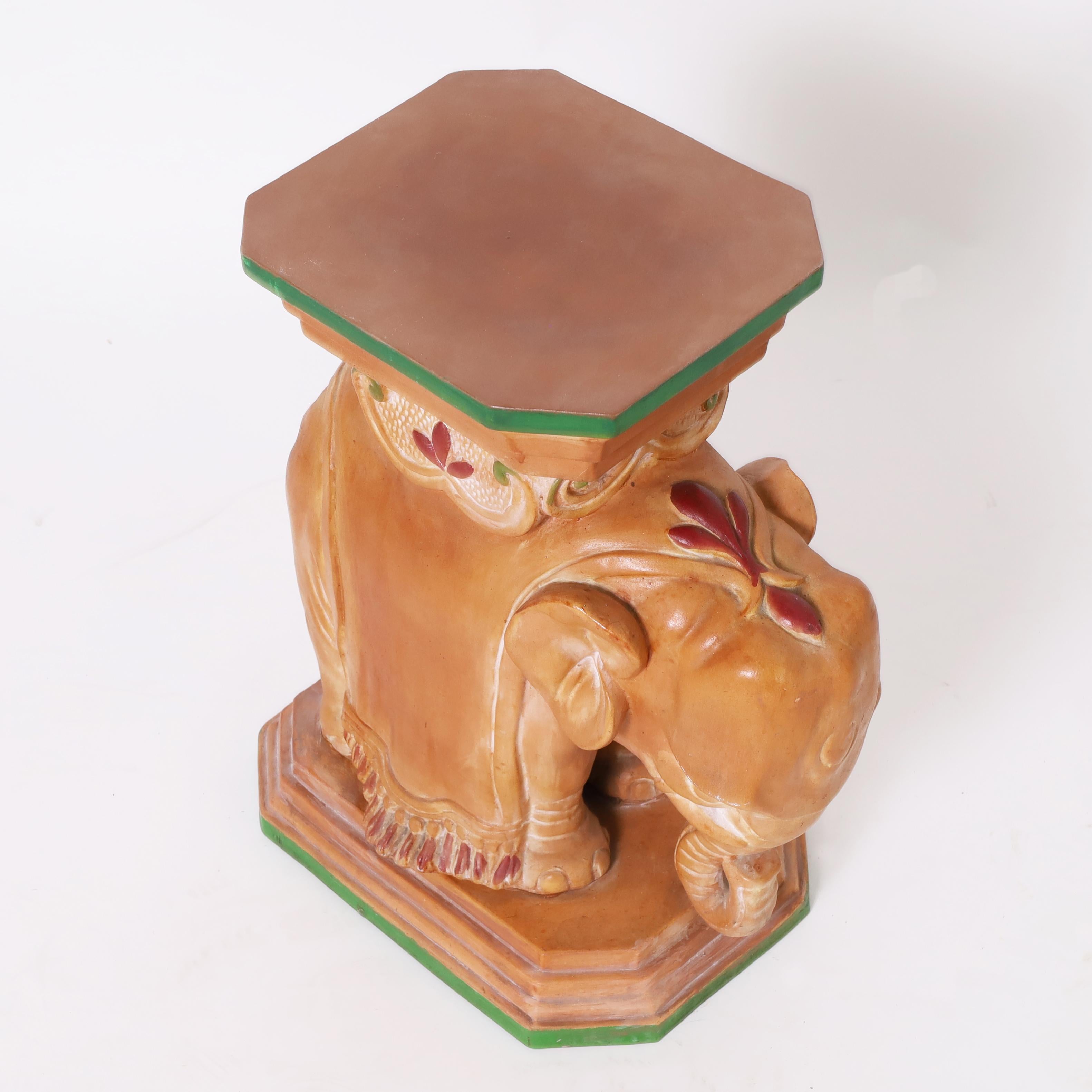 Mid century Italian elephant drinks or fern stand crafted in terra cotta and hand decorated with red and green paint. 