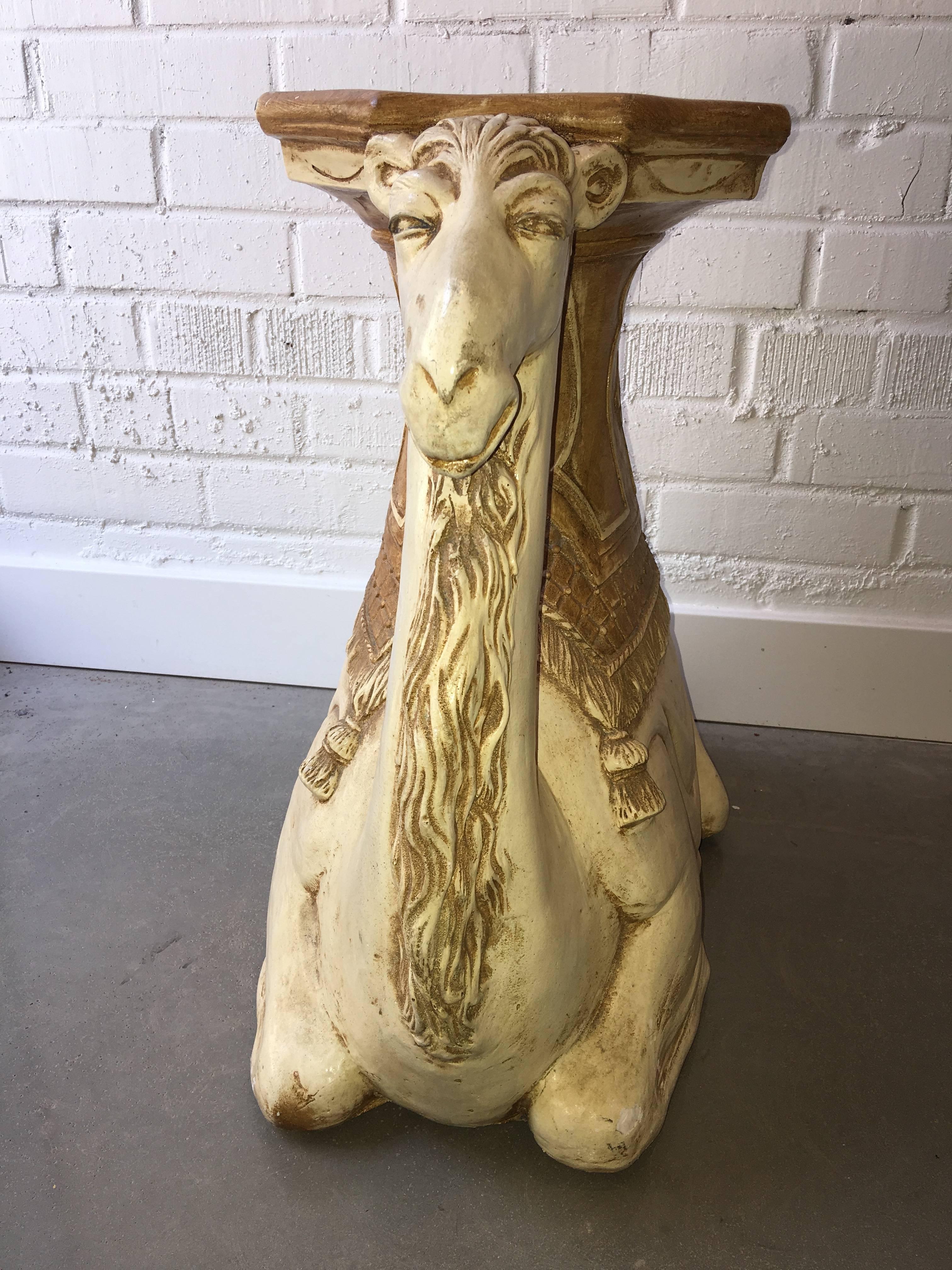 This camel is such a treasure! The perfect size as a side table or as a small coffee table. A piece of glass could be added to the top to increase the size for your daiquiri. Marked 