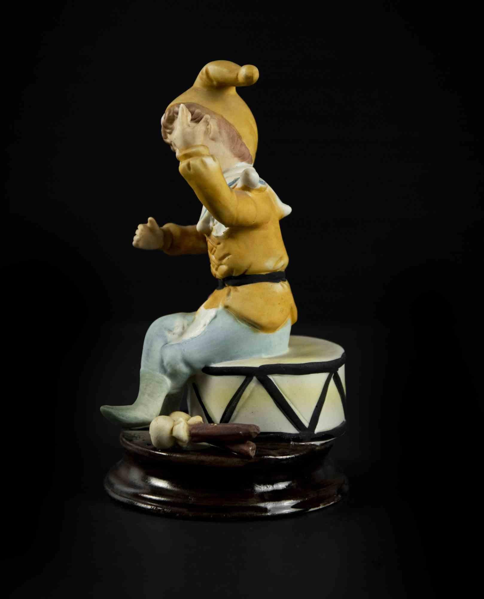 Child and Tambourine is an original decorative object realized in the second half of the 20th century.

Made in Italy. 

Original colored hand-made terracotta. 

The object is depicts a child that is standing on a tambourine with a funny
