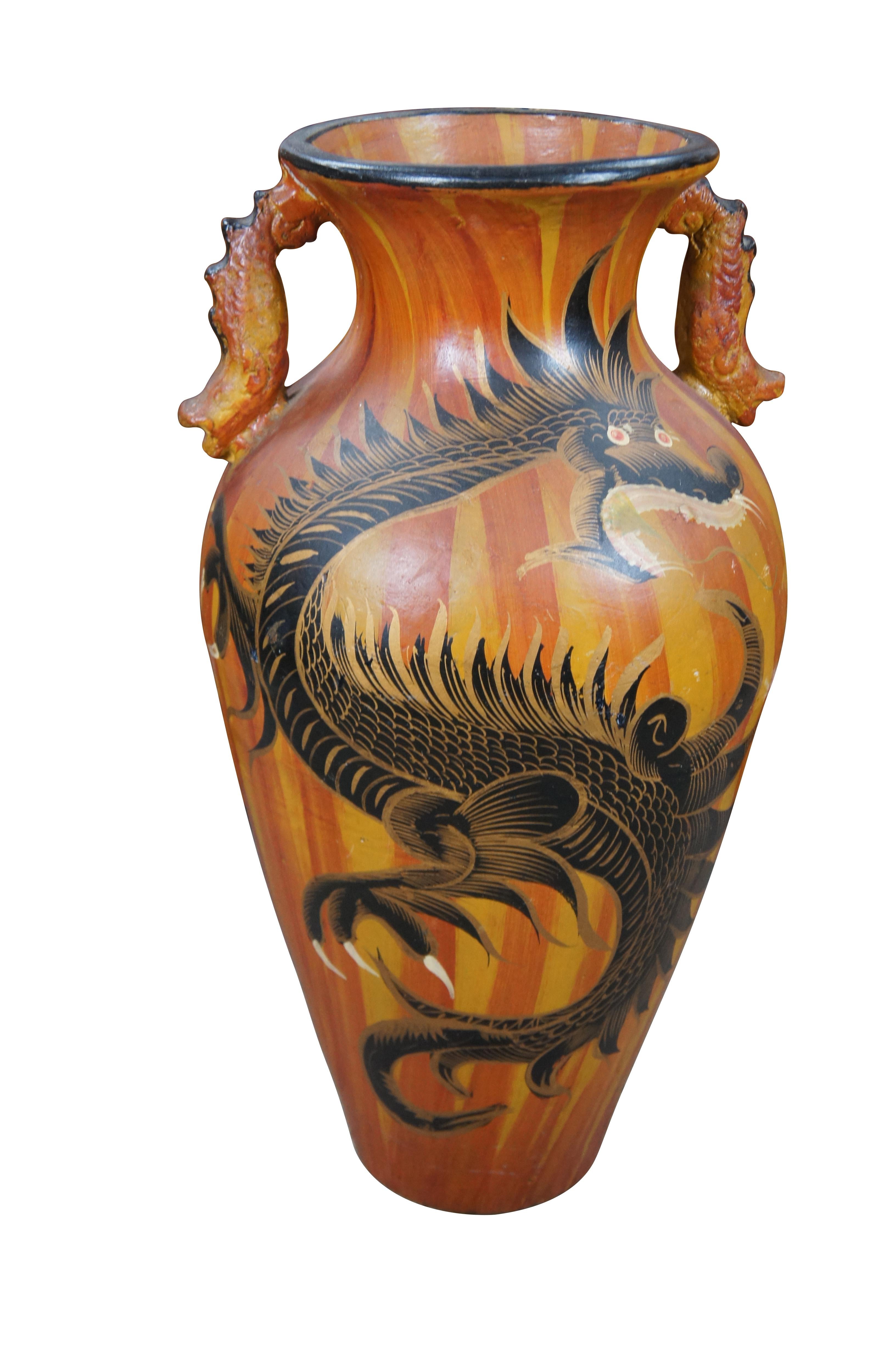 Large handled jar with a chinoiserie motif. Made from Terracotta with a dragon / floral motif painted over a red and yellow foreground. Features handles along the top.

Dimensions:
29