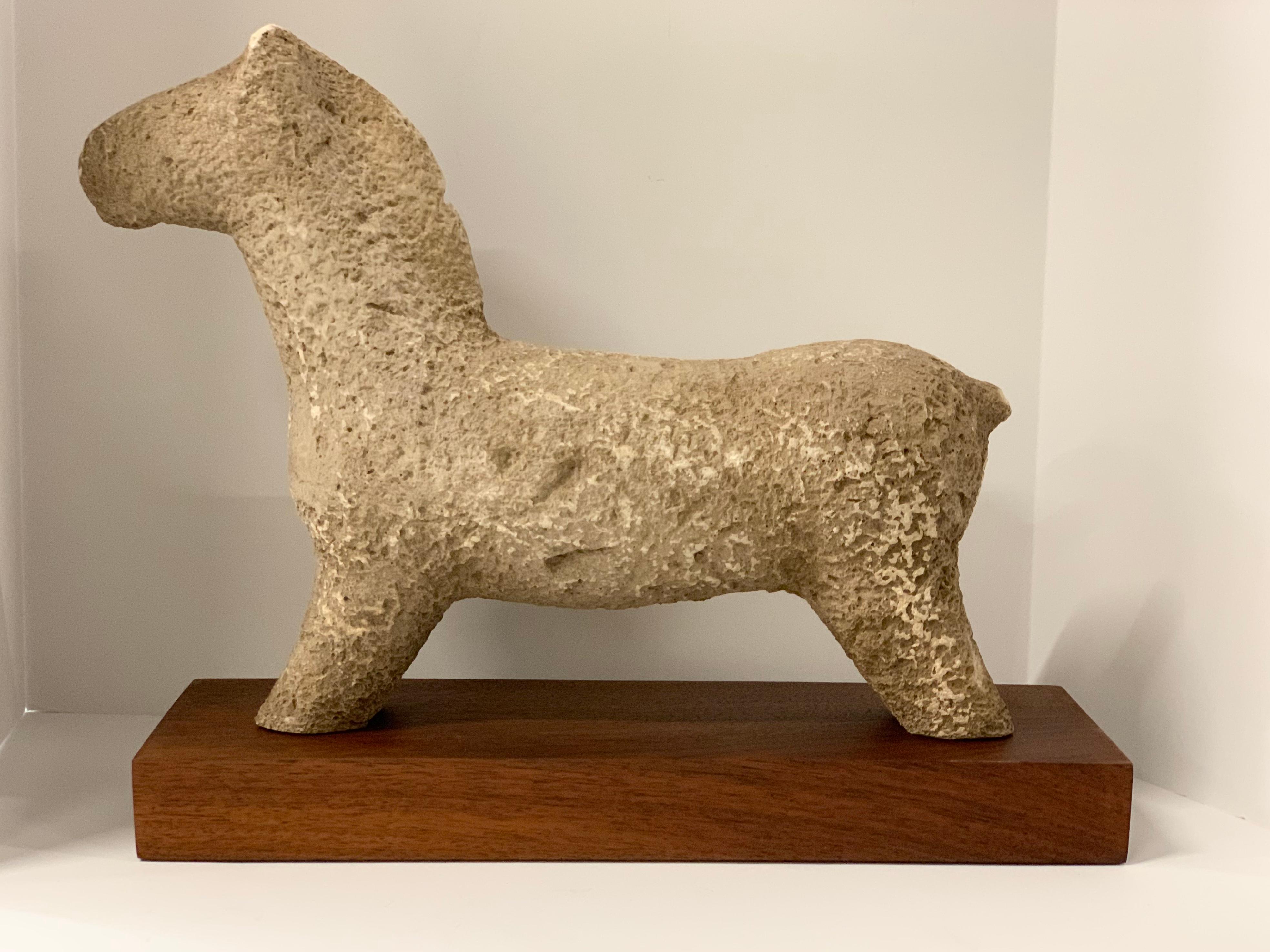 A vintage midcentury terracotta horse sculpture mounted on a mahagony base. Not signed that we can find. Horse has some losses particularly to ears and tail.
