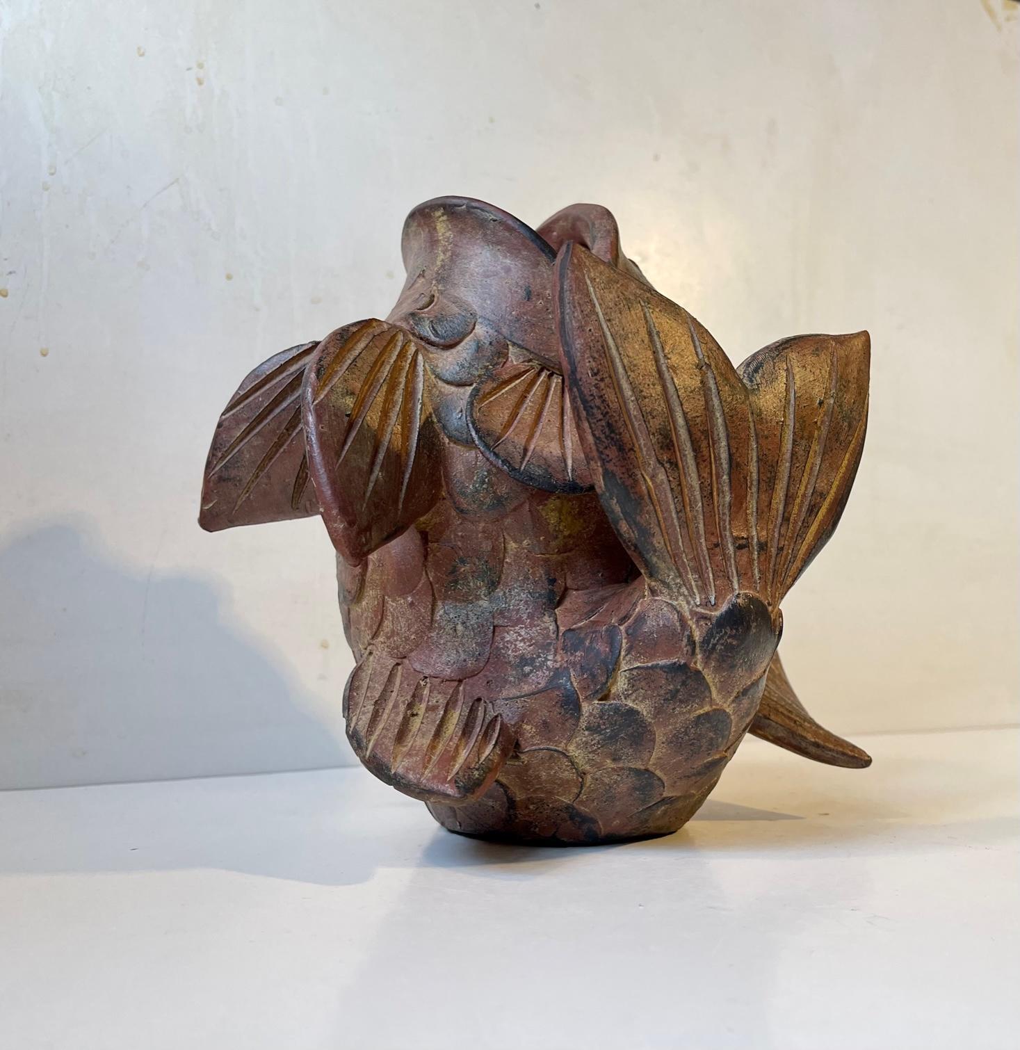 A sculptural Koi Fish vase in a tri-dimensional design. Its made from heigh-burnt terra cotta. It was made in Asia, possibly Japan, in the 1950s or 60s. Its very well-kept, clean and intact. Measurements: approx. 24 x 24 x 17 cm.
