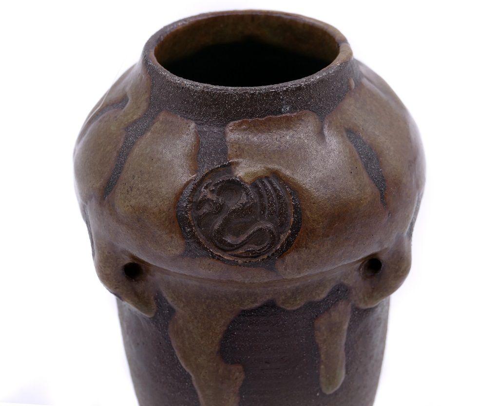 This vintage terracotta vase is a decorative object manufactured by Bornholm (Denmark) in the 1970s.

Brown terracotta vase in Chamotte clay.
A sticker attached on the bottom with written Bornholm Denmark.

Three original punches on the vase