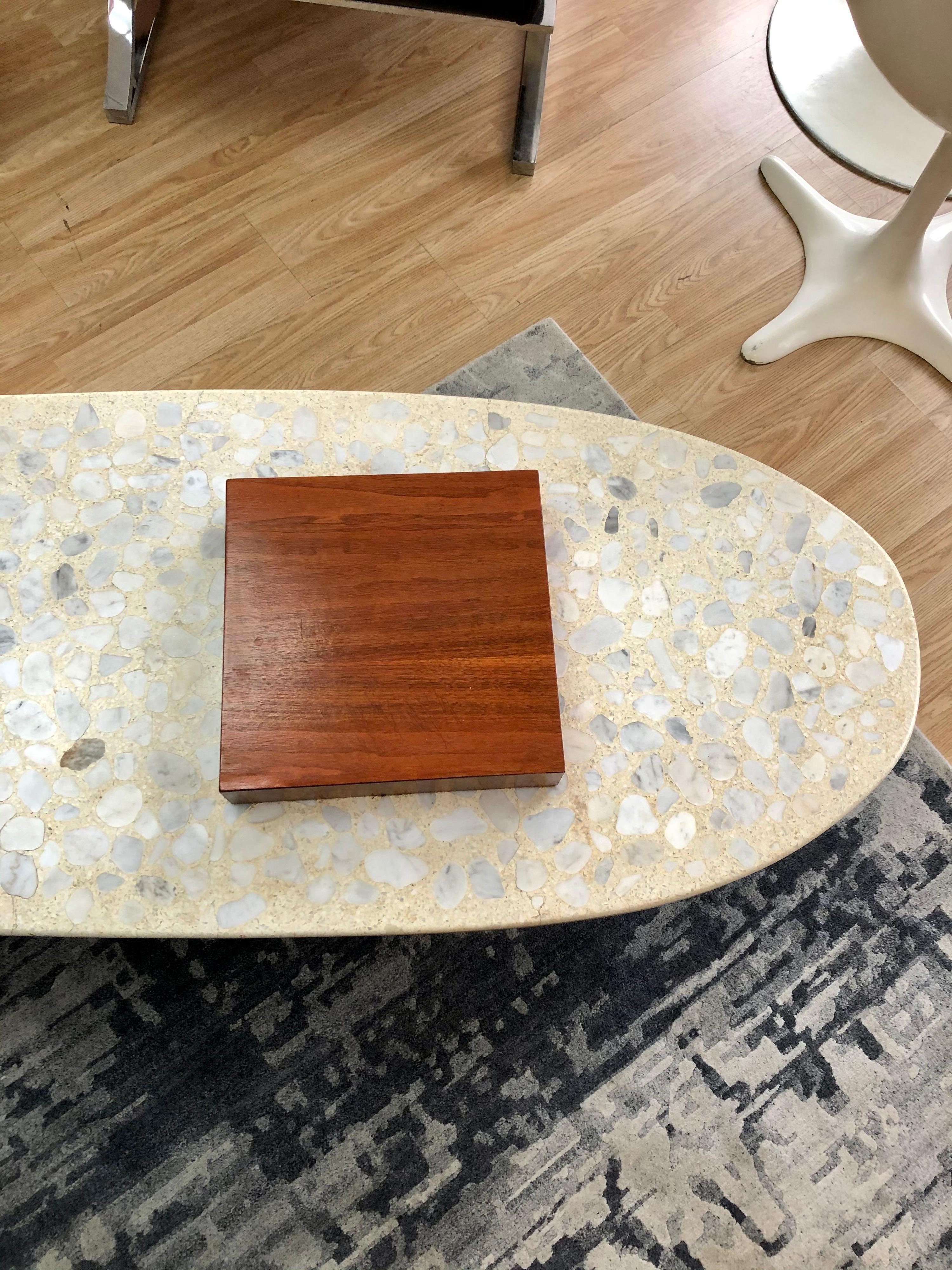 In the style of Harvey Probber, this stunning terrazzo coffee table is in overall good condition. Hairline cracks in Terrazzo tabletop. Walnut base. See photos. Unknown maker.
Dimensions:
66” D x 15” H x 22” W.