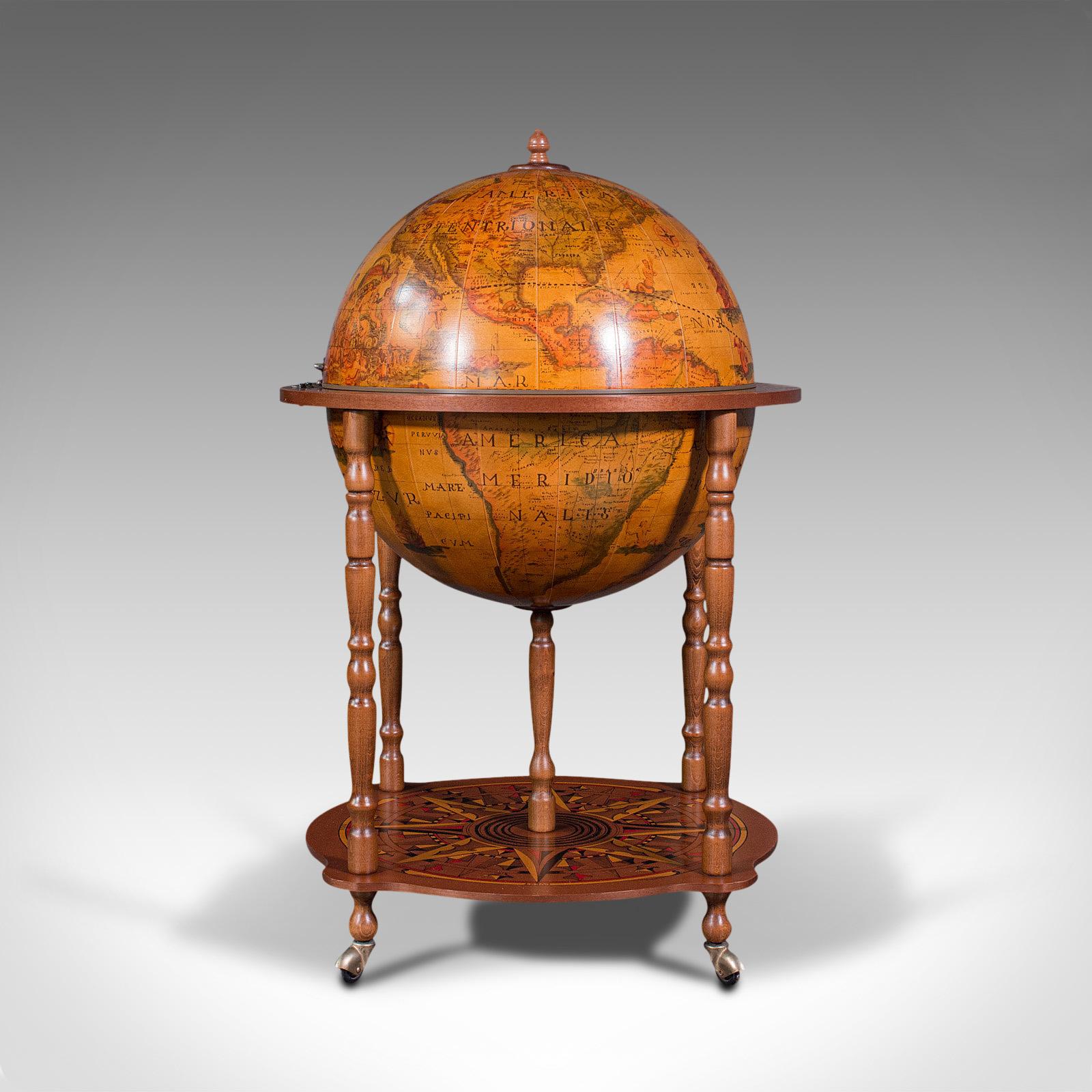 This is a vintage terrestrial drinks globe. A Continental, composite hardwood cocktail trolley cabinet, dating to the late 20th century, circa 1970.

Around the world in a responsible number of drinks
Displays a desirable aged patina and in good