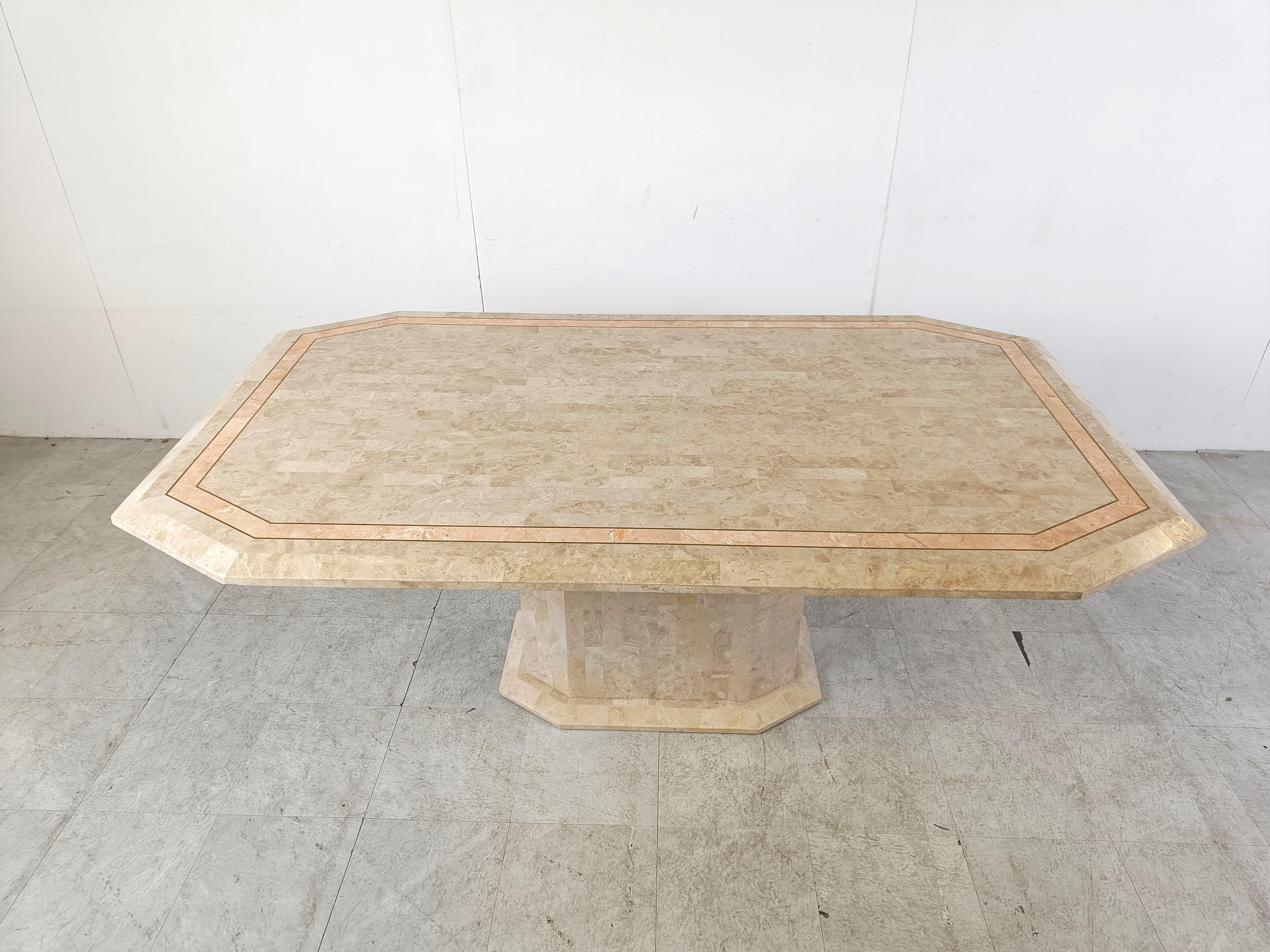 Gorgeous dining table made from tessellated stone.

The dining table has a very elegant table top with a central pedestal base.

Inlaid brass and contrasting inlaid red stone.

Good size to accommodate 6-8 persons.

Very good