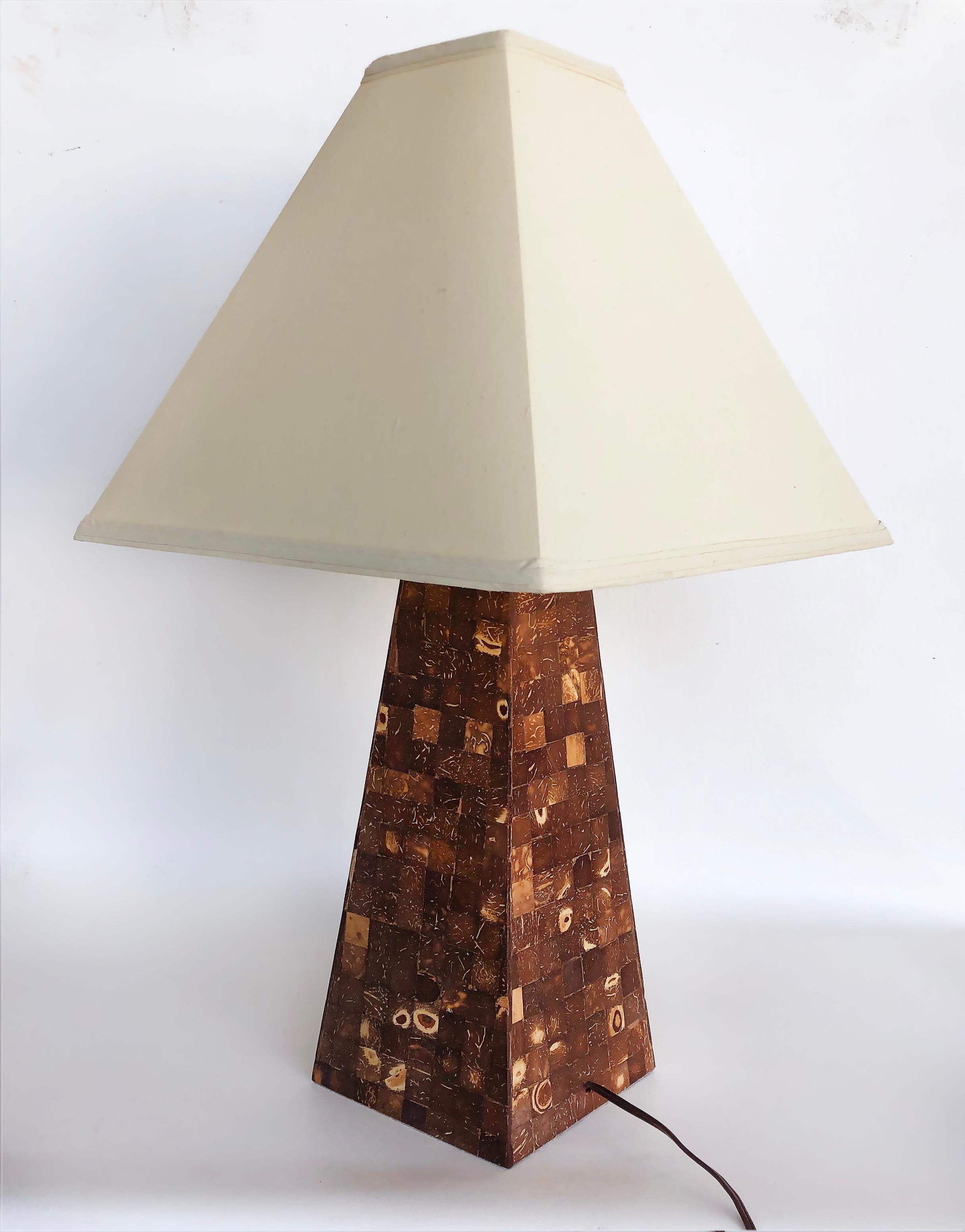 Vintage Tessellated coconut shell table lamp

Offered for sale is a vintage tapered column form table lamp that this clad in polished tessellated coconut shell tiles. The lamp is elegant and will work nicely in many design settings. The lamp is