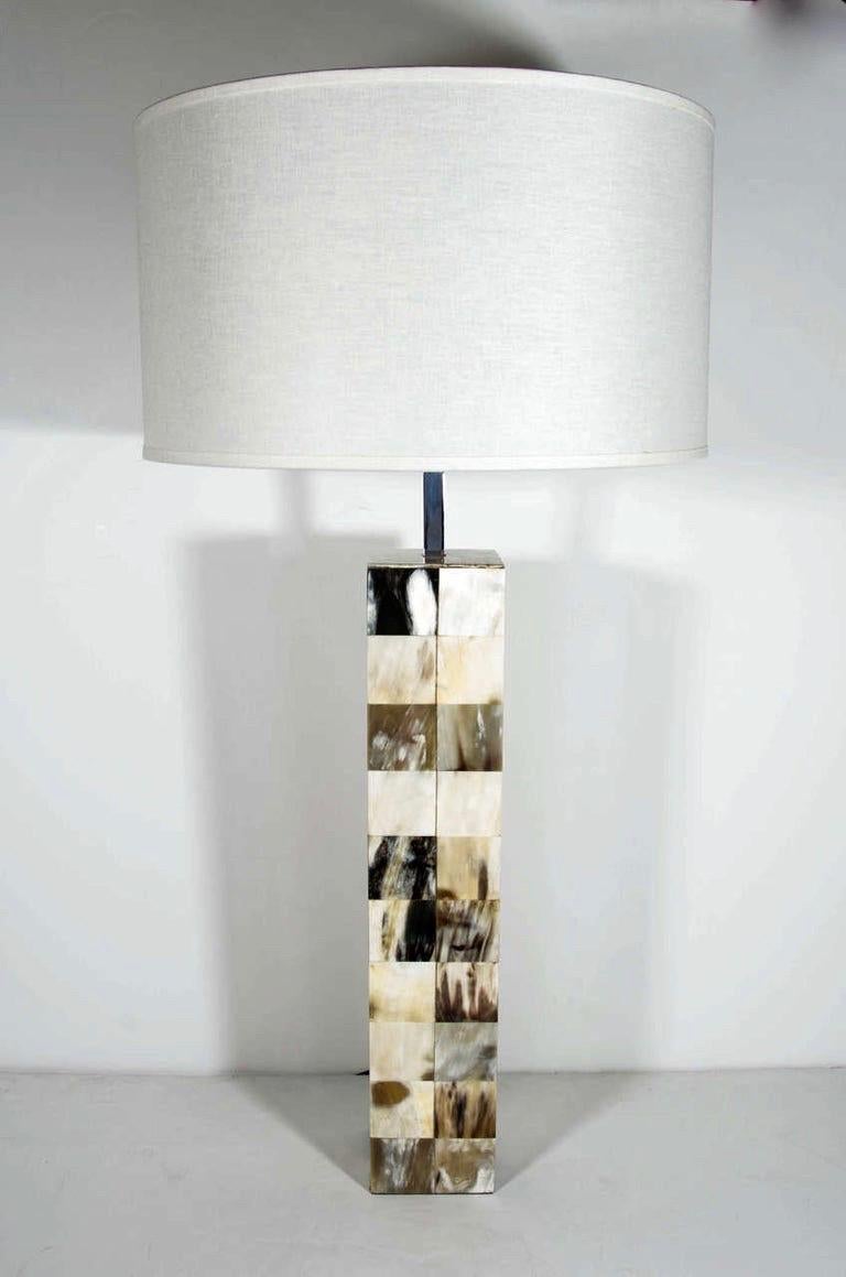 Post-Modern lamp in genuine tessellated horn. Column frame comprised of inlaid horn squares in gradient hues of ivory, tan, black, brown and grey. Fitted with a chrome stem, newly rewired, and shown with linen drum shade.