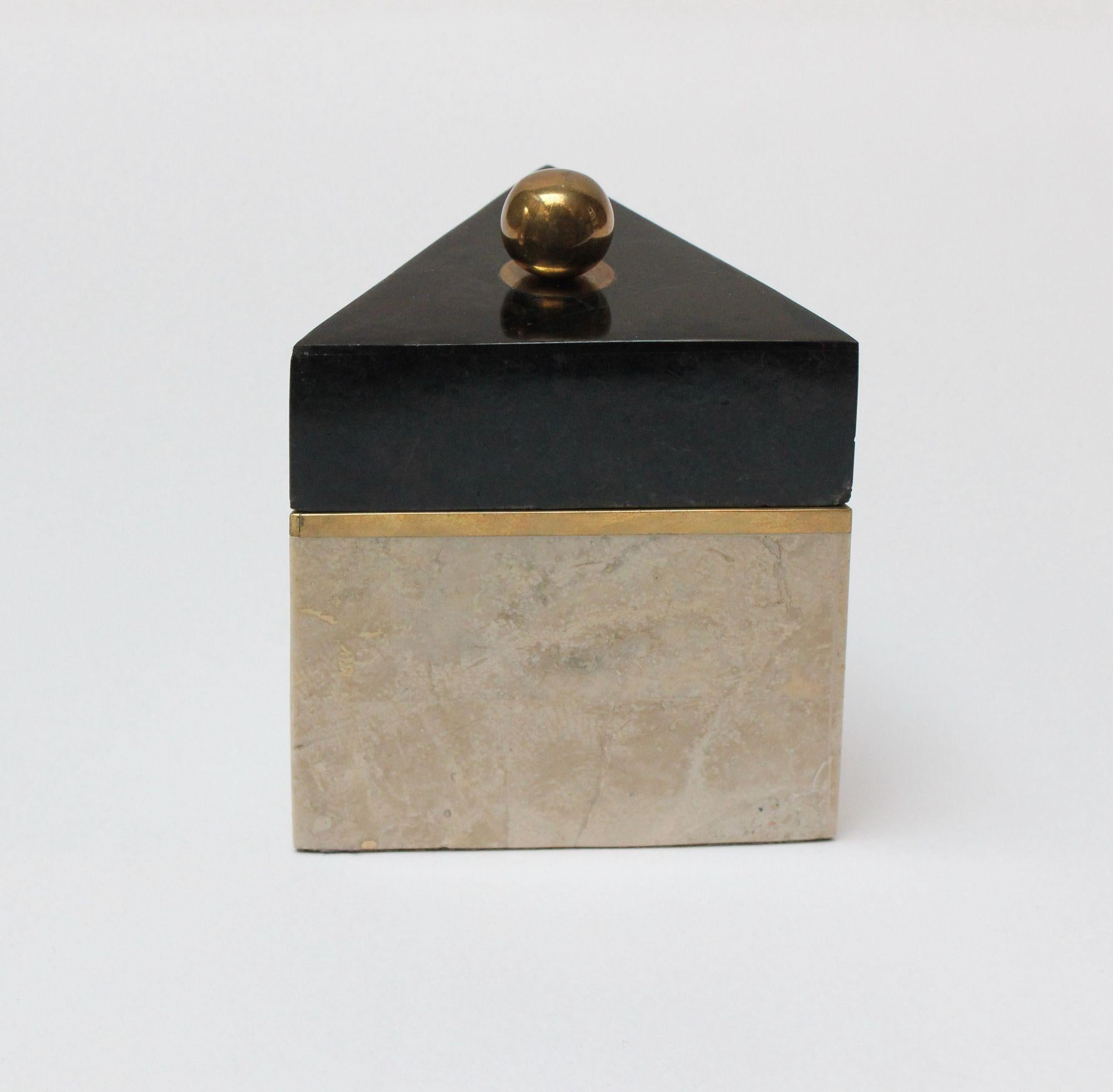 Vintage Maitland Smith attributed triangular box in tessellated marble and black stone with brass inlay and knob with black felted interior.
Small size and unique, triangular shape measuring H: 6.25