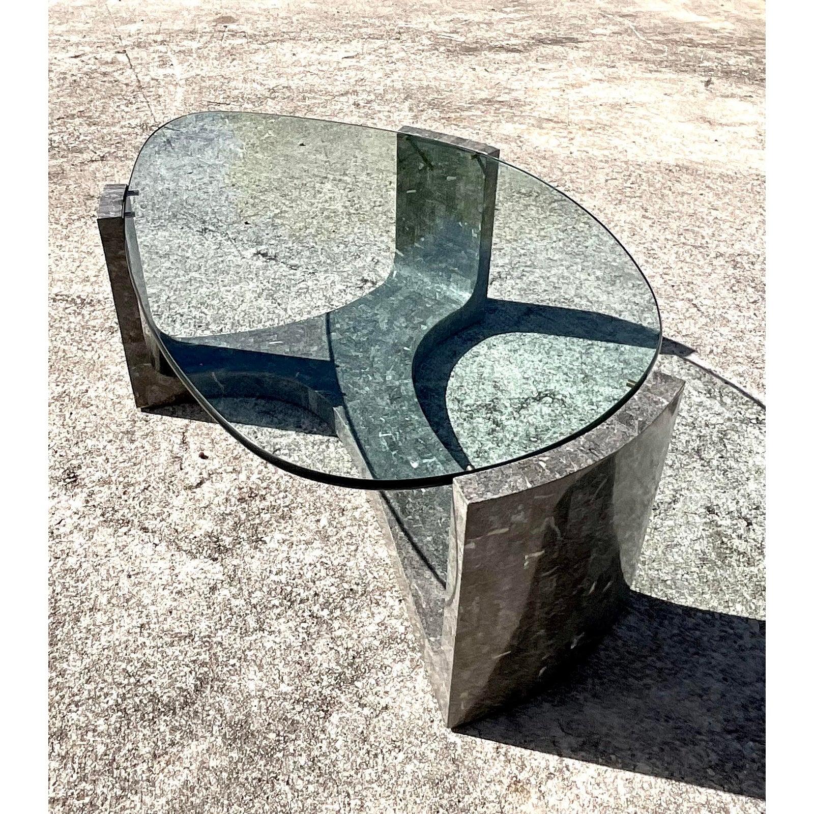 Fantastic vintage tessellated stone coffee table. Beautiful pale grey stone in a chic contemporary design. Thick glass gives this table the distinctive look of luxury. Done in the manner of Maitland-Smith. Acquired from a Palm Beach estate.