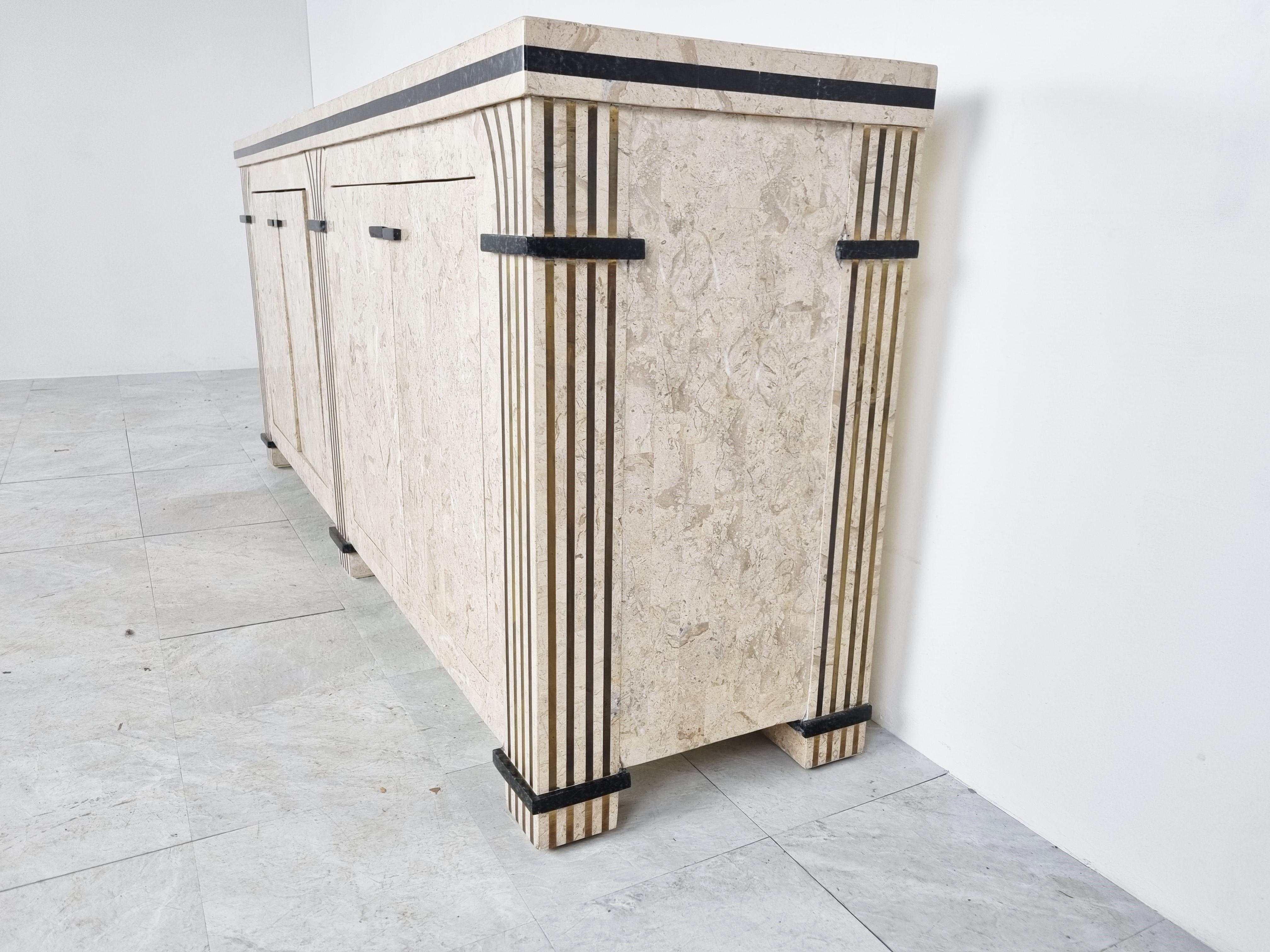 Rare tessellated stone/marble sideboard in the manner of Maitland Smith.

Beautifully finished with inlaid brass.

The inside of the sideboard has also a matching finish.

Good condition

1980s - USA

Dimensions:
Lenght: