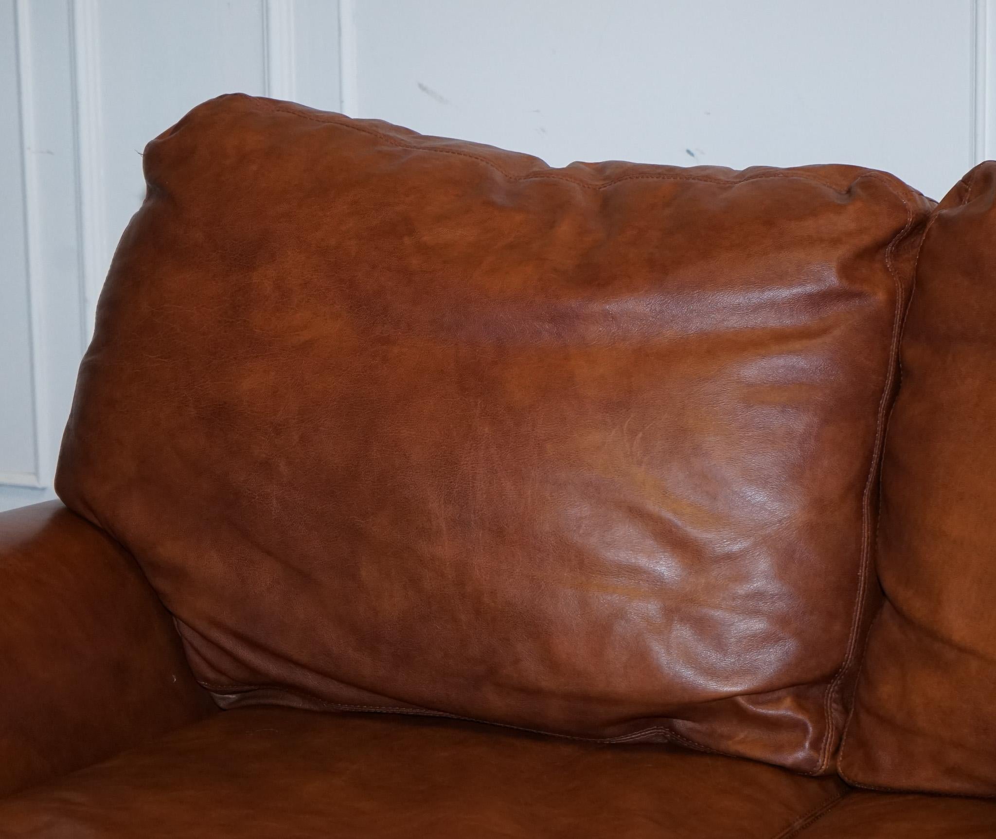 We are delighted to present this stunning Tetrad Tan leather Cordoba 2-seater sofa.

We have sold this model many times in the past and have always been really happy with the quality. It is retailed by John Lewis.

The cushions are still very plum
