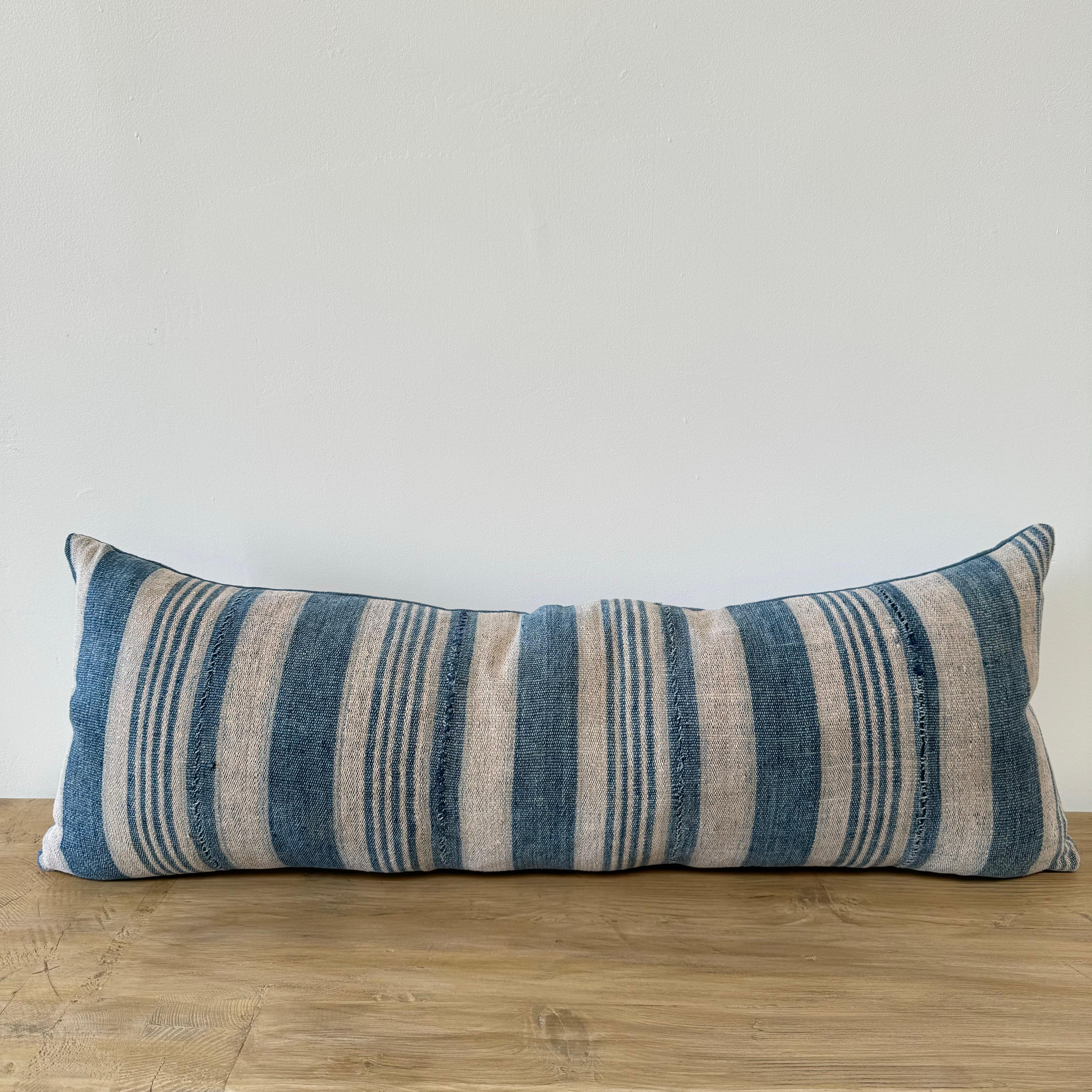 Vintage one of a kind blue batik stripe lumbar pillow
Face is a hemp linen stripe with stitched fabric panels, in a multi blue stripe.
The back is a solid coordinating blue linen
Size: 11