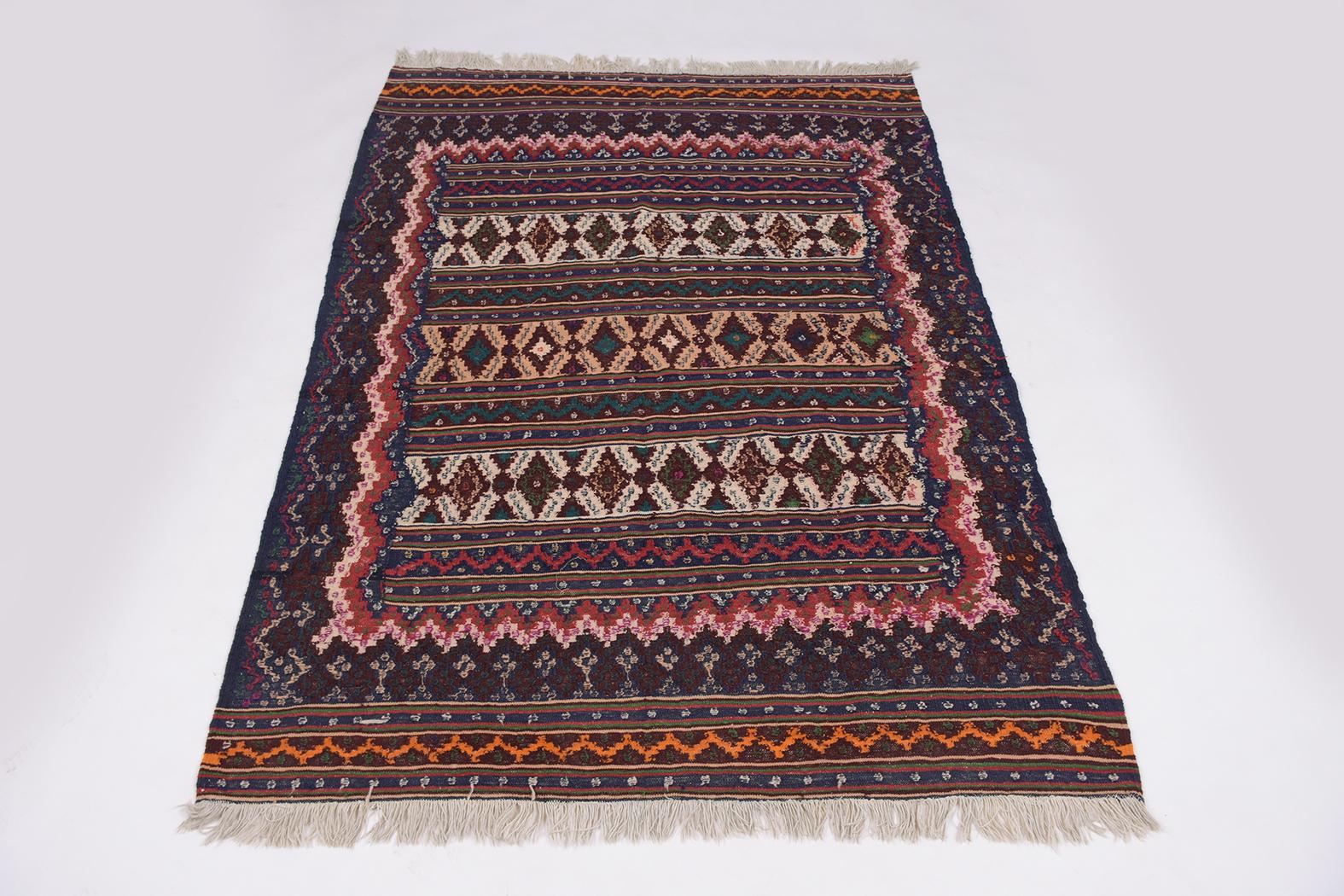 An extraordinary textile rug in great condition beautiful hand-crafted out of wool, this vintage throw rug is eye-catching features an asymmetric multi-color and tassels design perfect for a unique living room design inspiration decor.
