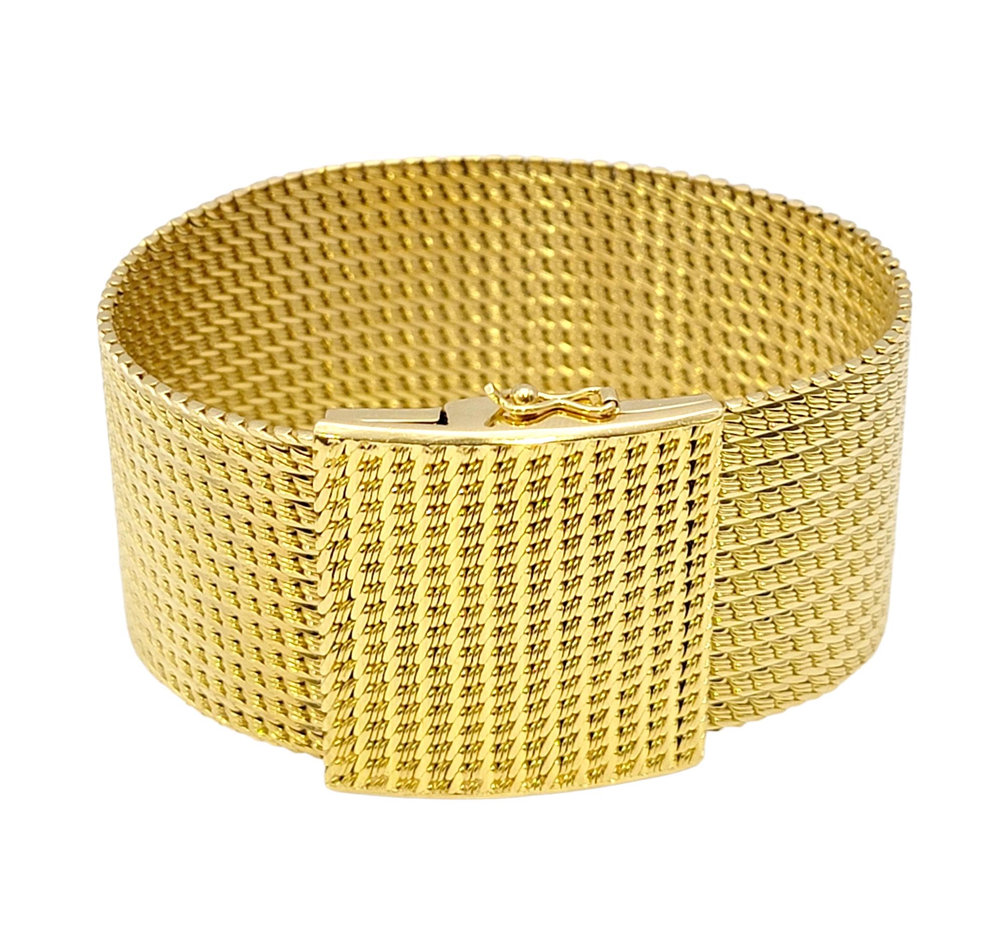 Striking wide mesh bracelet. The flexible style hugs the wrist for a comfortable and secure fit, while the simple yet luxurious design goes with just about everything. 

This striking piece features a wide polished 18 karat yellow gold flexible