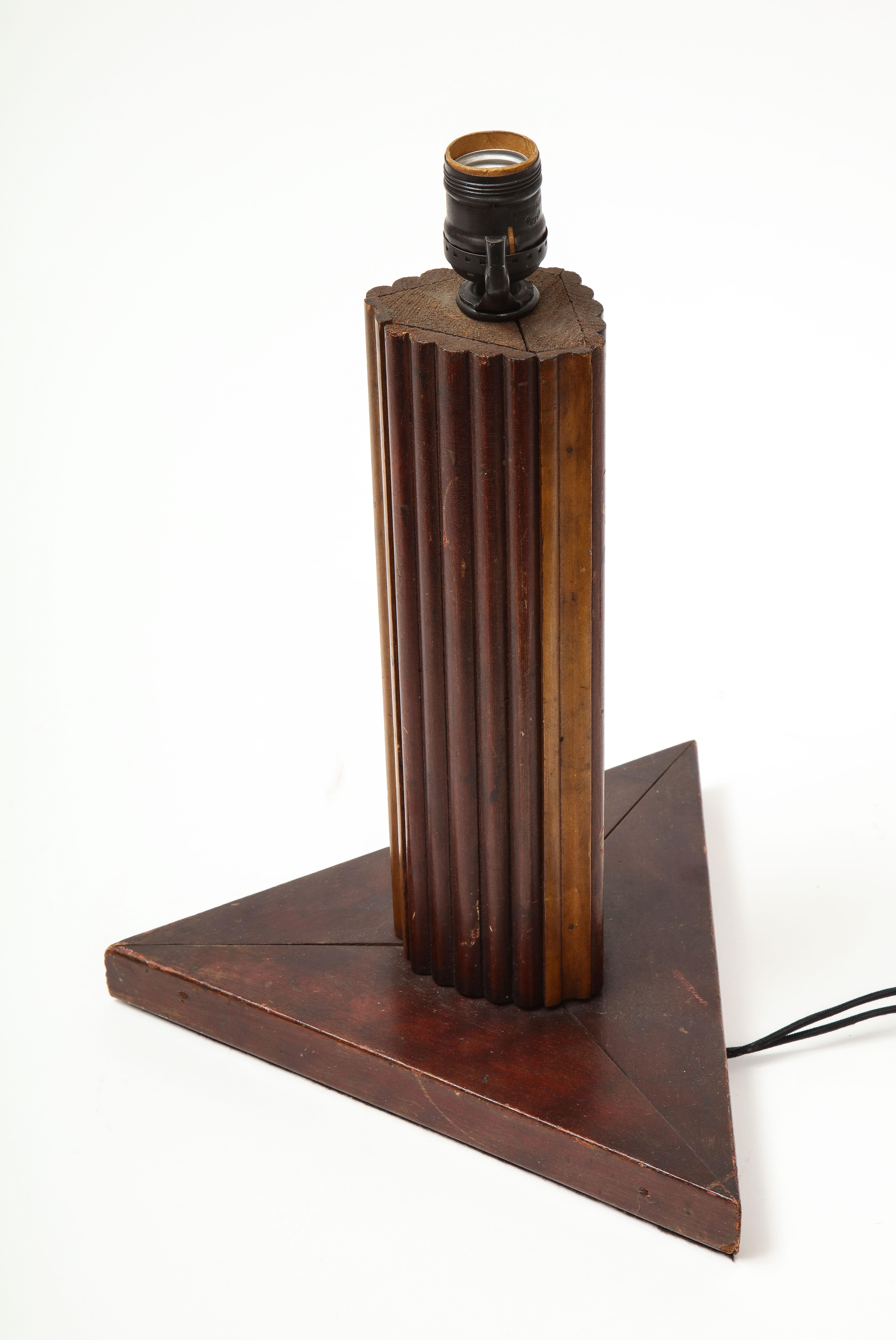 Vintage textured wooden table lamp with triangular base and fluted edge detail, France, 20th century.
 