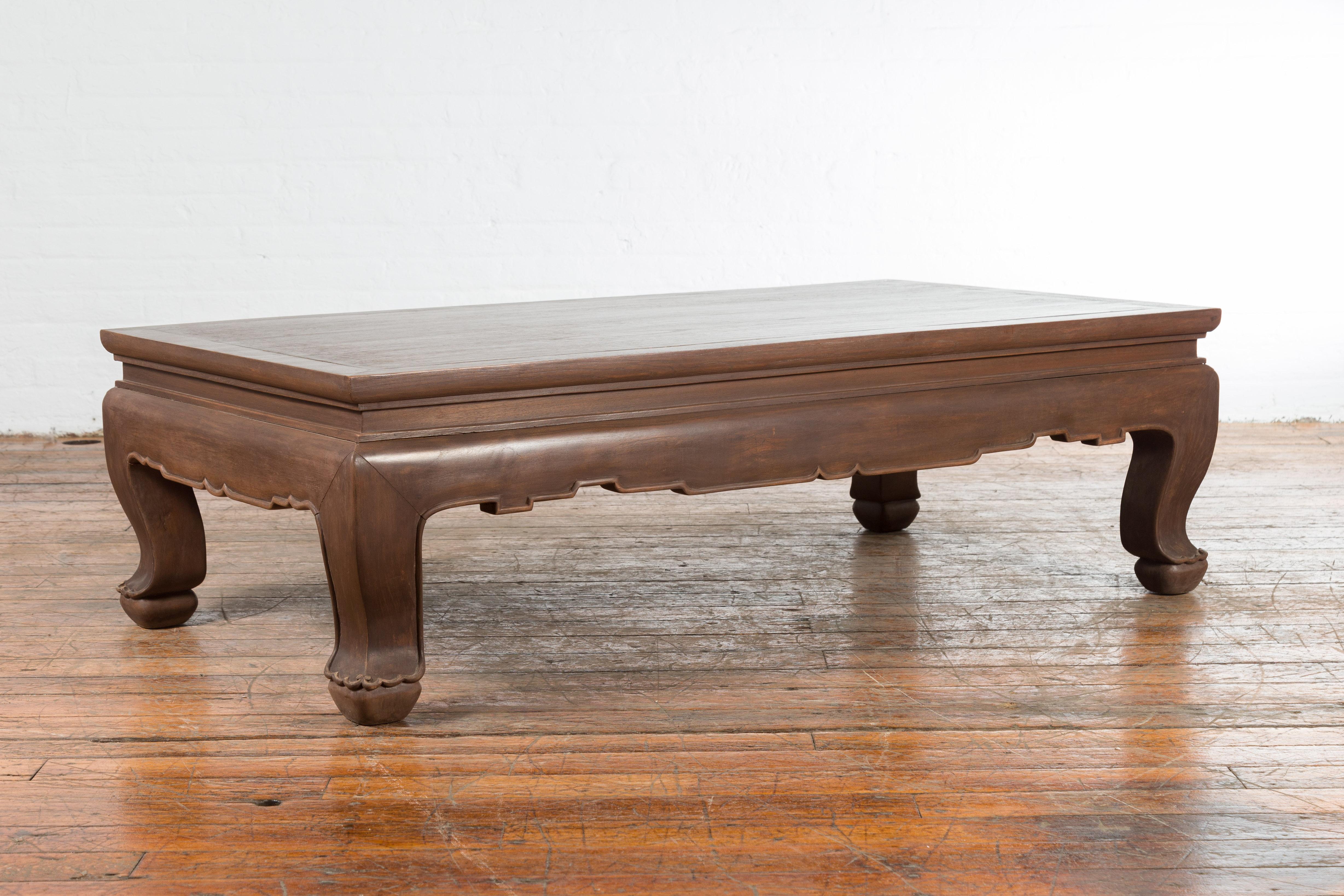 20th Century Vintage Thai Brown Wooden Coffee Table with Waisted Carved Apron and Chow Legs For Sale
