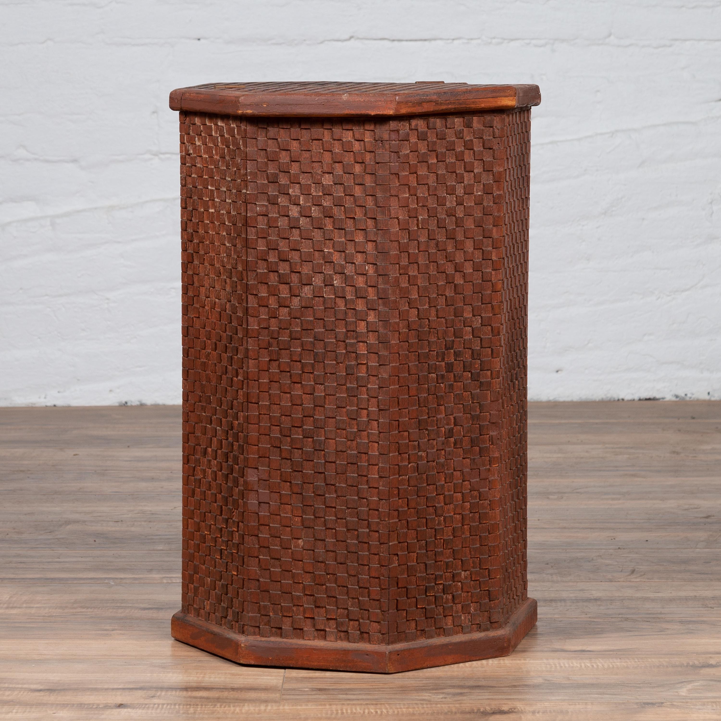 A Thai vintage hexagonal wooden clothes hamper from the mid-20th century, with checkered patterns. Born in Thailand during the mid-century period, these charming clothes hamper features a hexagonal shape adorned with checkered motifs. The top
