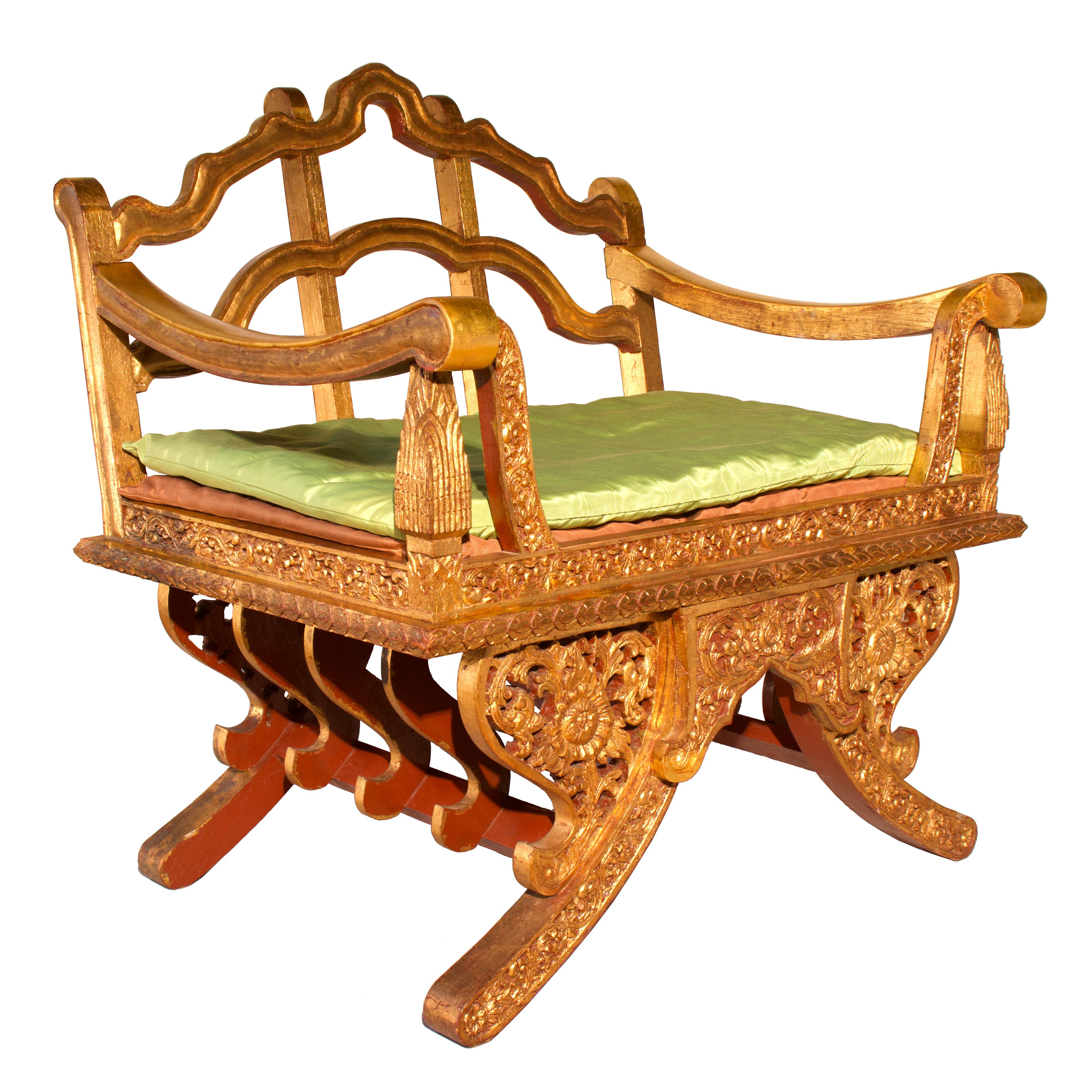 Vintage Thai Howdah-style Meditation Chair, teak, lacquer, gold leaf, Mid-20th century. A highly decorative and ornately carved throne, evocative of the royal processionals of Siam. A sturdy construction consisting of four bowed legs to straddle the
