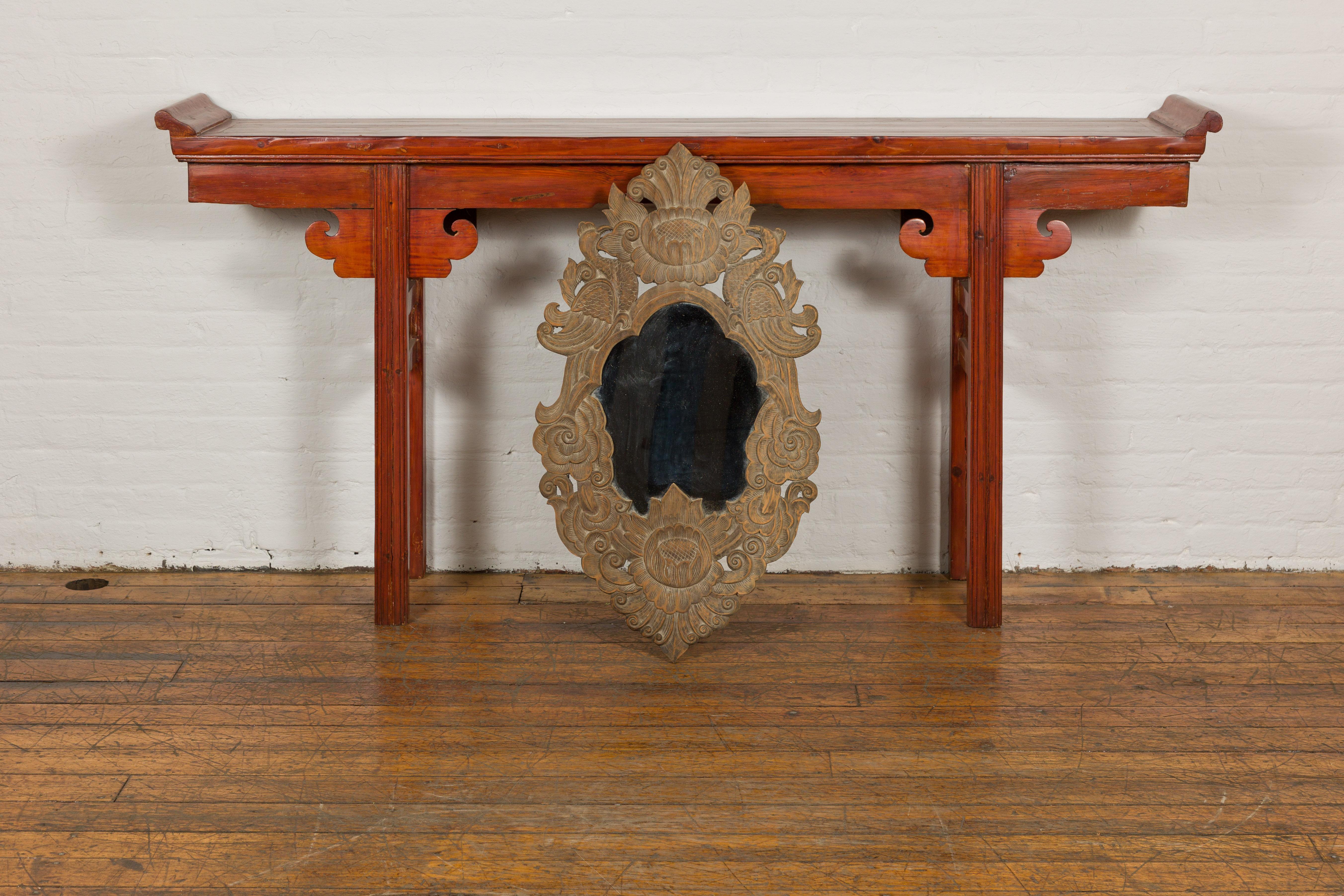 Thai wooden mirror from the mid 20th century with richly carved foliage, birds and flower décor. Emanating a sense of timeless elegance and undeniable artistry, this mid 20th century Thai wooden mirror is a wonderful example of traditional Thai