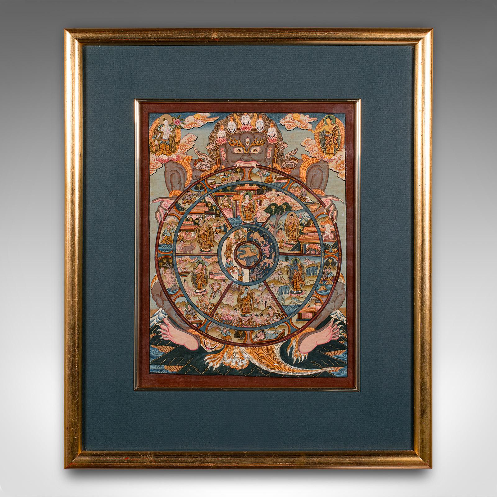 
This is a vintage Thangka 'Wheel of Life' painting. An Indian, handpainted linen Buddhist panel, dating to the mid 20th century, circa 1960.

Originating as a profound depiction of the teachings of Shakyamuni Buddha, the Thangka Wheel of Life is a