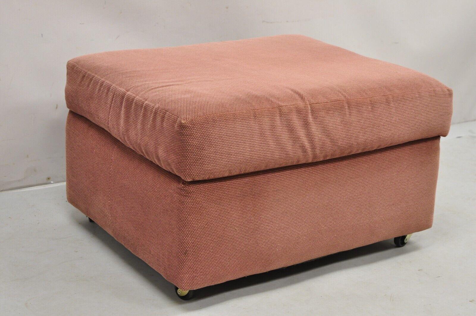 Vintage Thayer Coggin Modern Upholstered Mauve Color Ottoman footstool on Wheels. Circa Late 20th Century. Measurements: 16