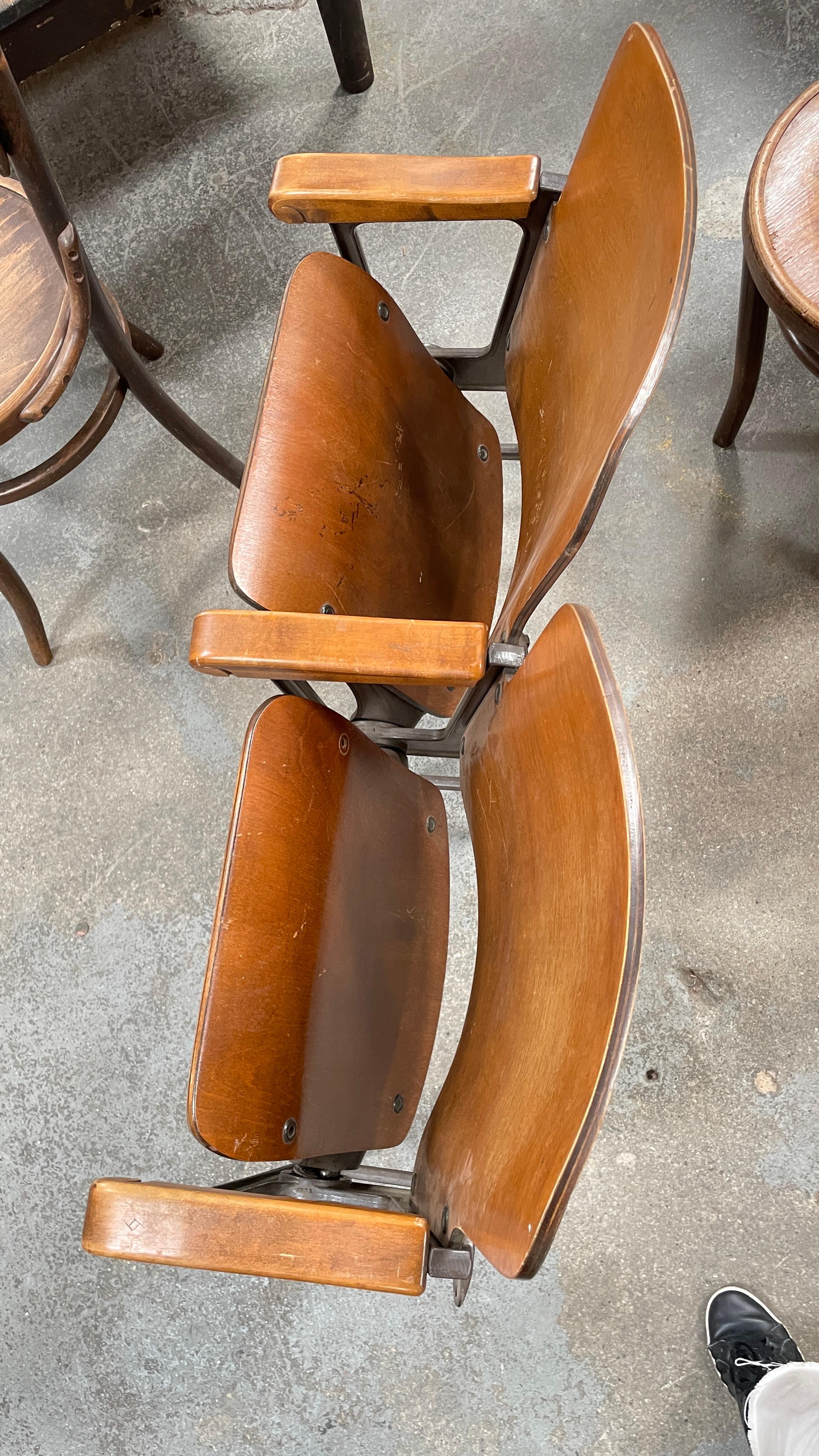 Two vintage foldable theater seats connected by metal frame. Seats can be folded up or down and do not require wight to stay in the down position. The patina is consistent with age and use. They are in good condition and surprisingly comfortable.