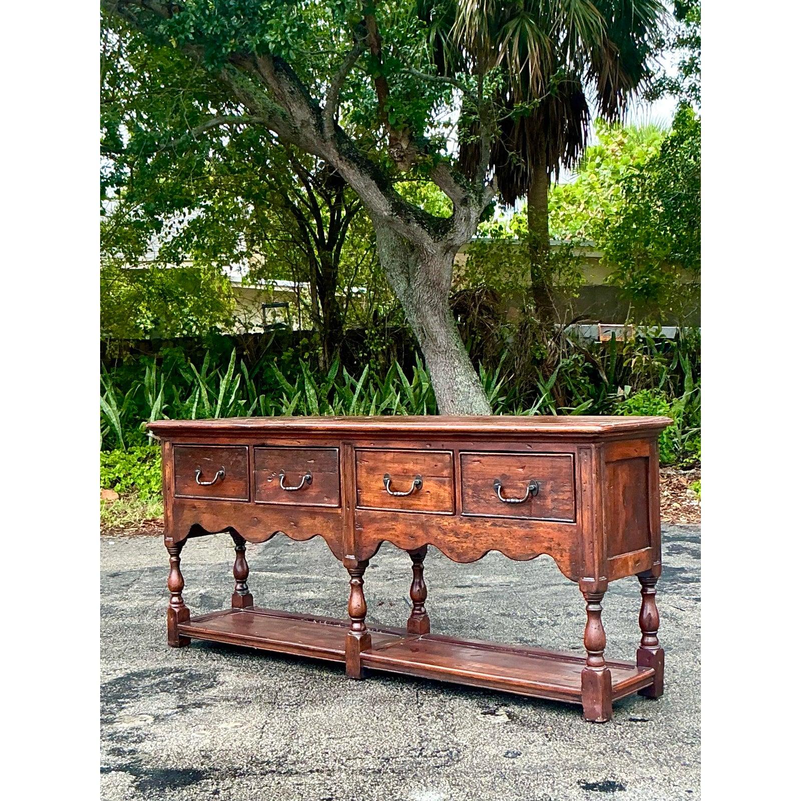 Introduce enduring style and ample storage to your space with this handsome vintage sideboard or console table. Crafted from solid wood, likely pine as suggested by its rustic potential, and featuring a warm, dark finish, this piece blends