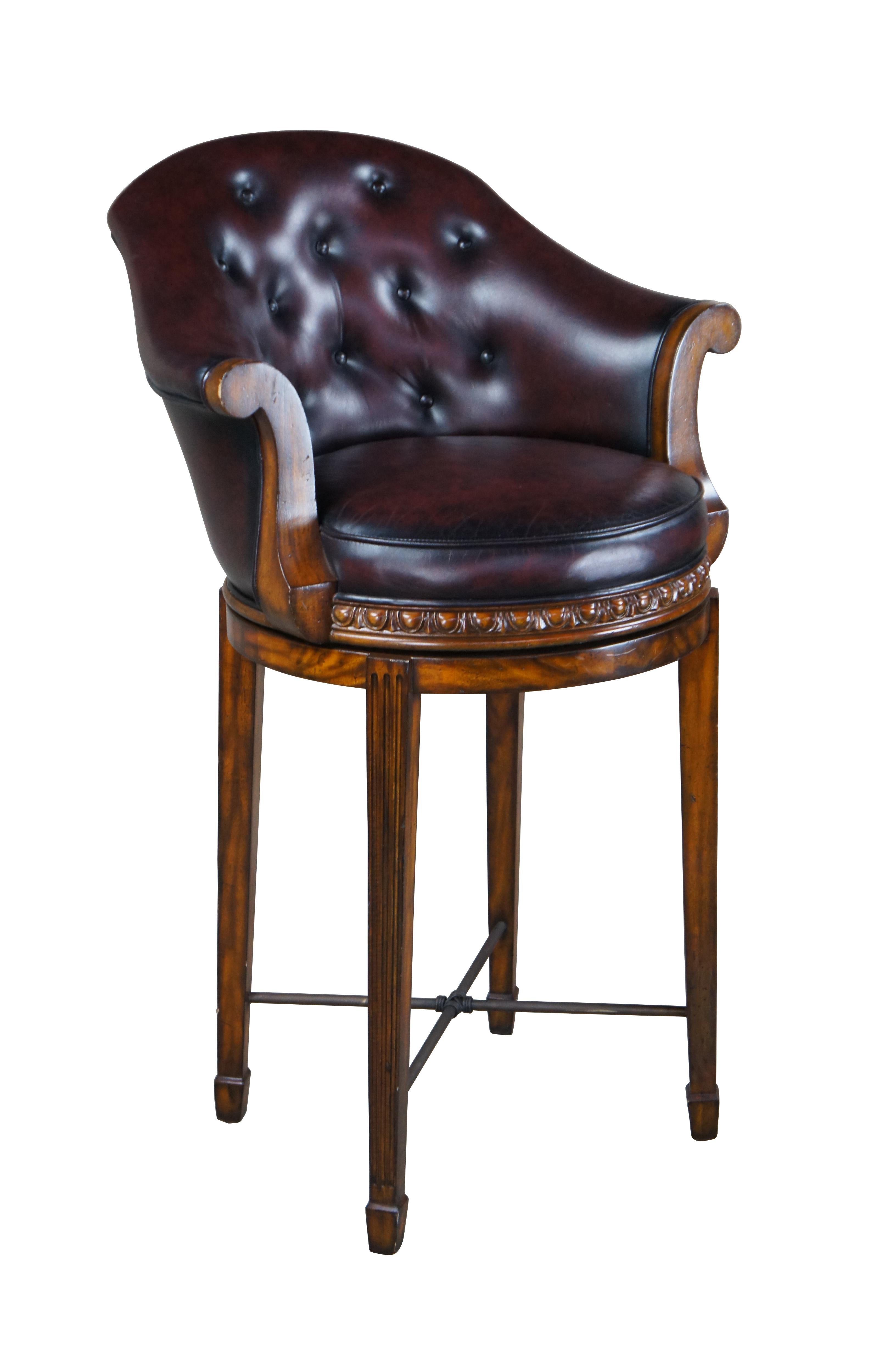 Vintage Theodore Alexander swivel bar or counter stool.  Made of flamed mahogany featuring flared arms, domed back and tufted leather.

Dimensions:
26