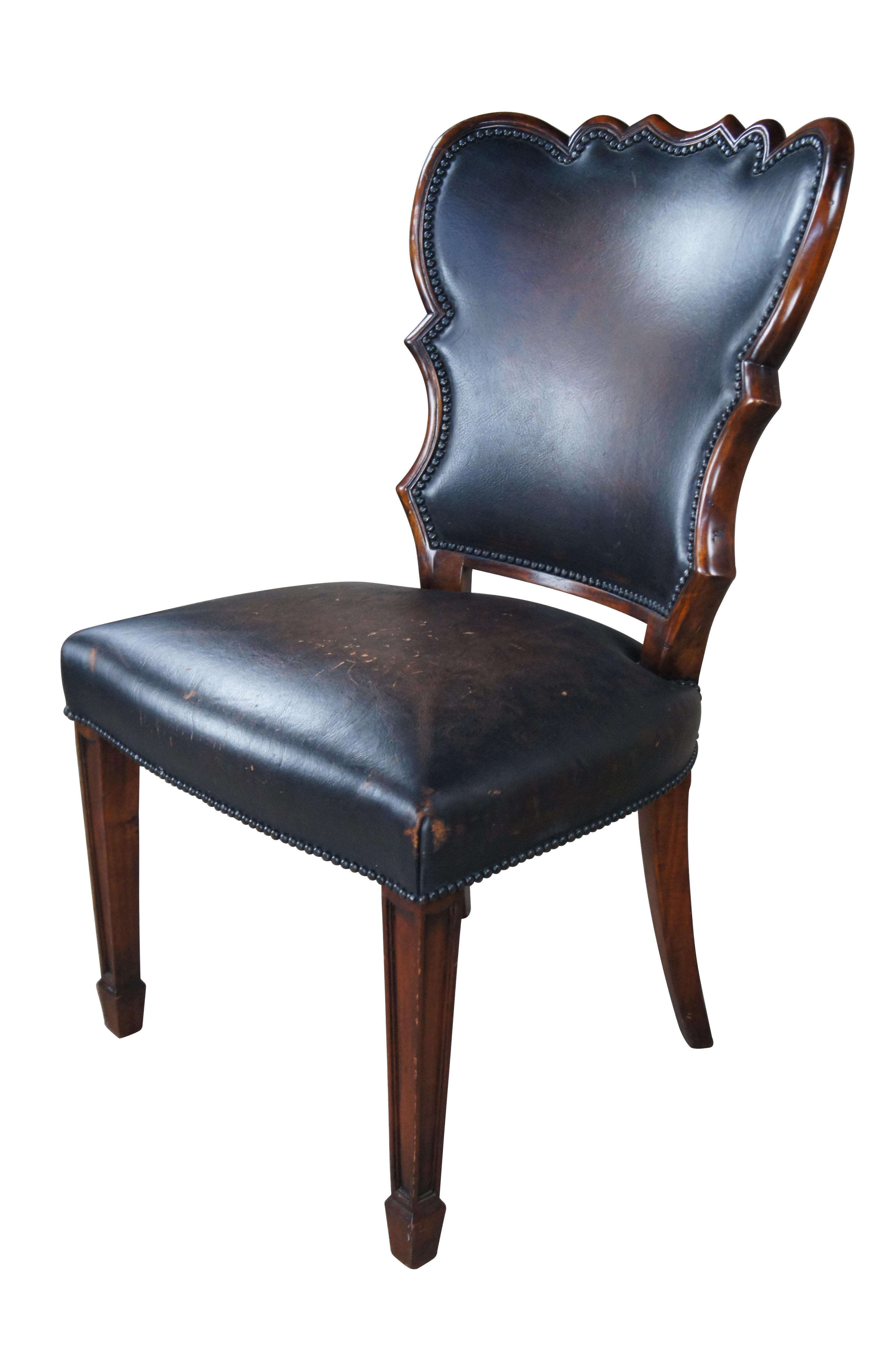 An exquisite late 20th century side chair by Theodore Alexander.  Designed in the manner of Sheraton / Federal styling with a sculptural back and large seat over square tapered legs leading to spade feet.  Rear legs are saber shaped.   The chair is