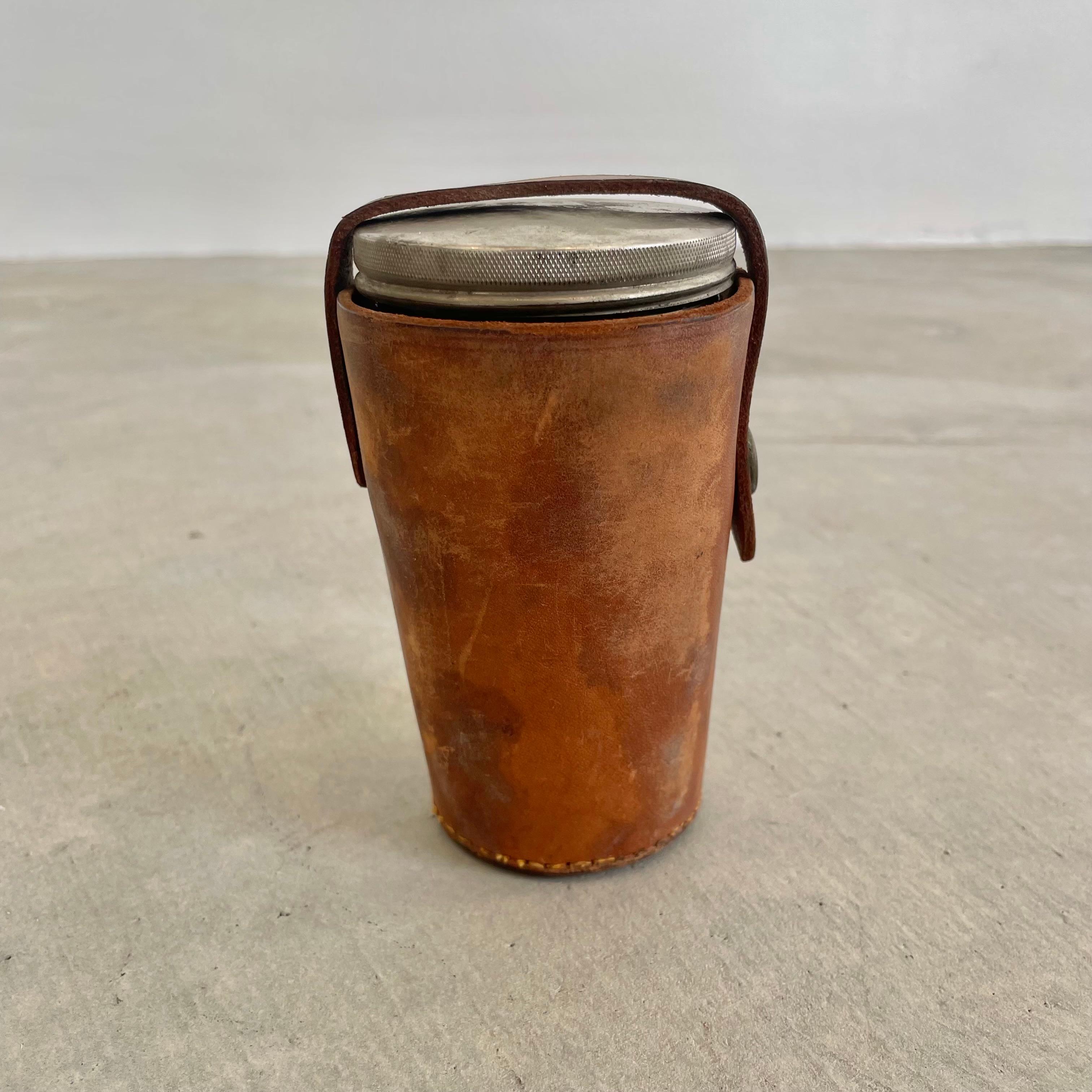 Set of 4 metal Thermos cups from the early 1900s in great condition with a thick cowhide cover and a lid. Incredible condition to metal cups for being over 100 years old. Leather cup holder assumed to have been remade in the 60s. Great for camping