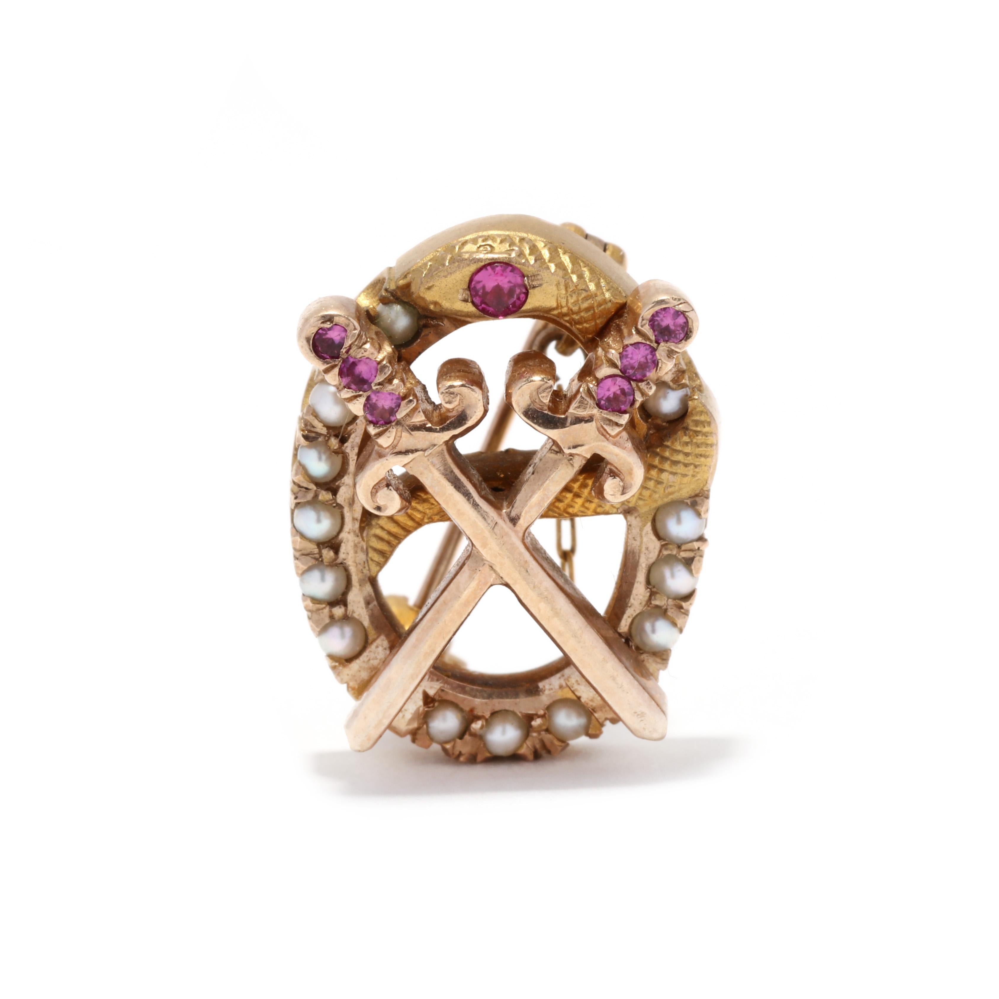 A vintage 10 karat yellow gold, synthetic ruby and seed pearl Theta Chi fraternity pin. This pin features an oval design with a coiled snake motif and two crossing swords, set with round cut synthetic rubies and seed pearls.

Length: 5/8 in.

Width: