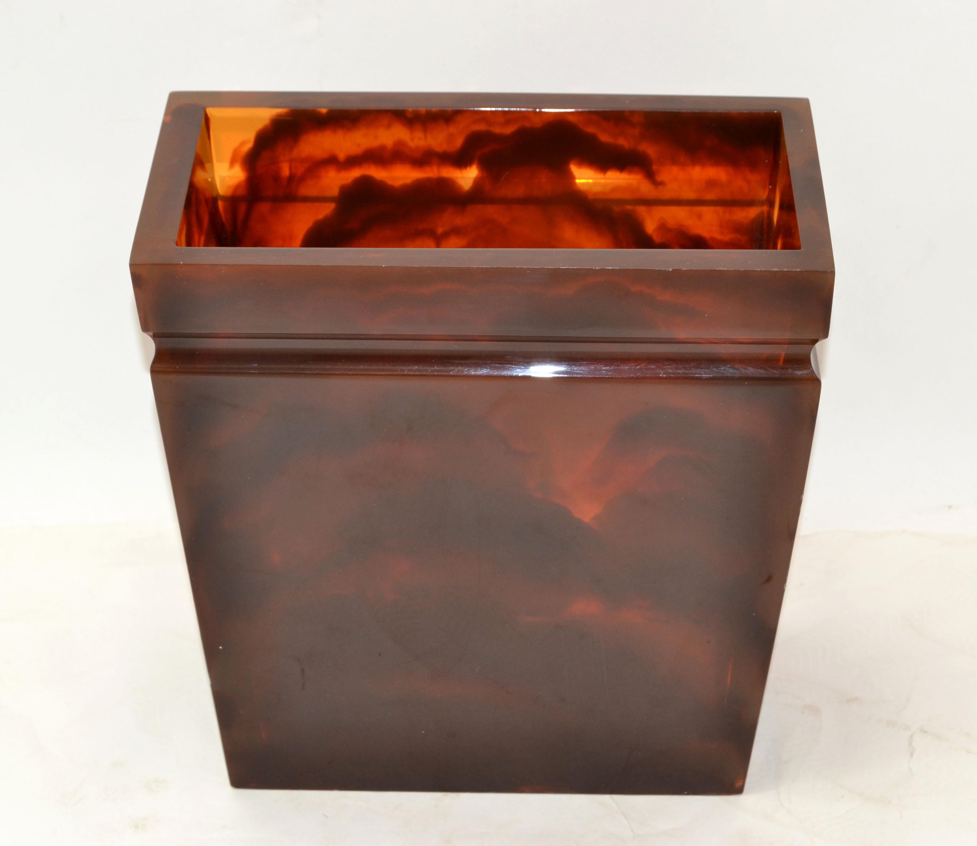 American Mid-Century Modern thick Lucite trash basket, waste can or umbrella stand in an dark Amber marble pattern.
Made in the USA circa 1970.