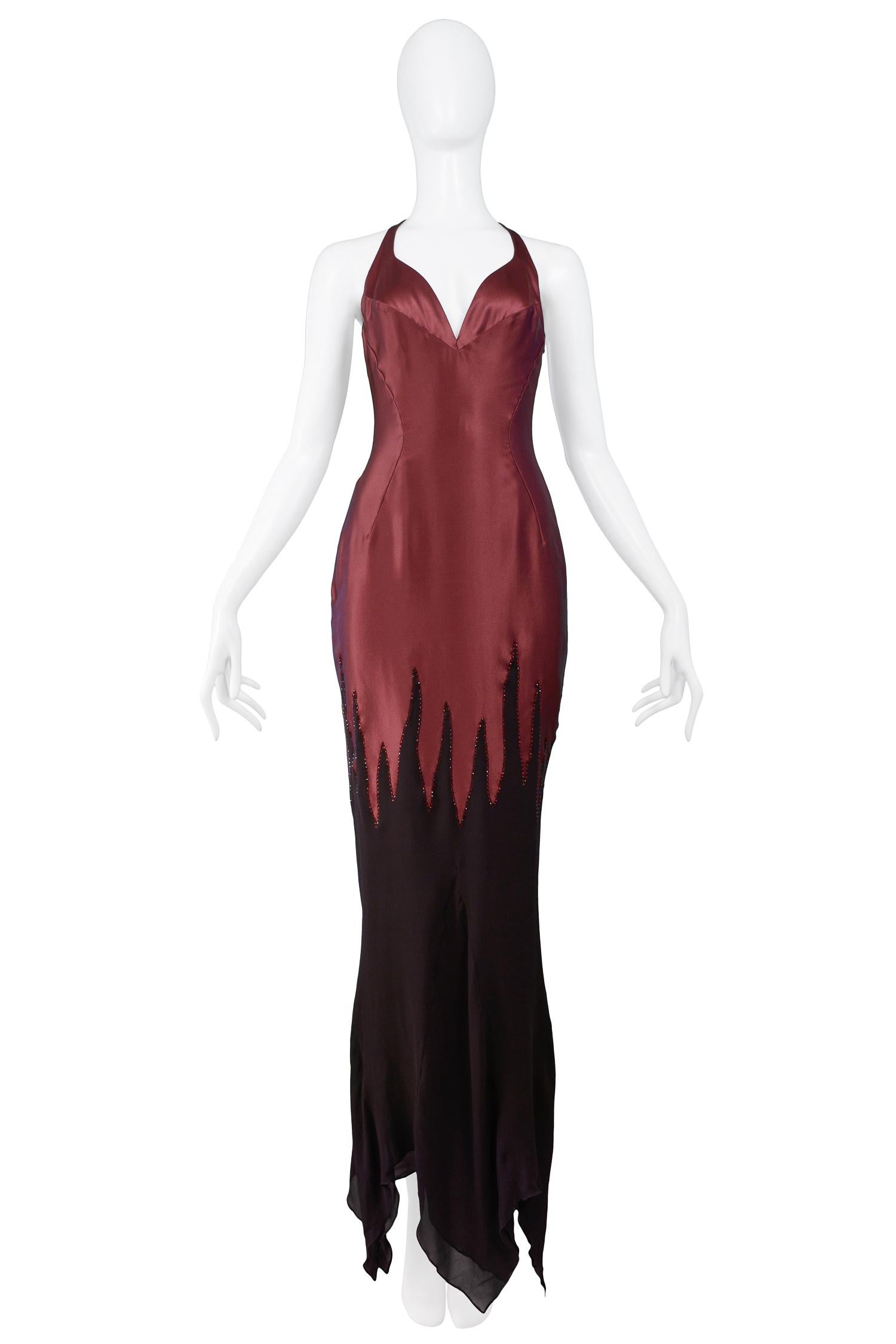 Vintage Thierry Mugler burgundy silk charmeuse gown featuring a fitted bodice with curved v-neck, low back with t-strap, and aubergine chiffon flame tip detail at skirt with glass beading and rhinestones. 

Excellent Condition.

Size: 40 