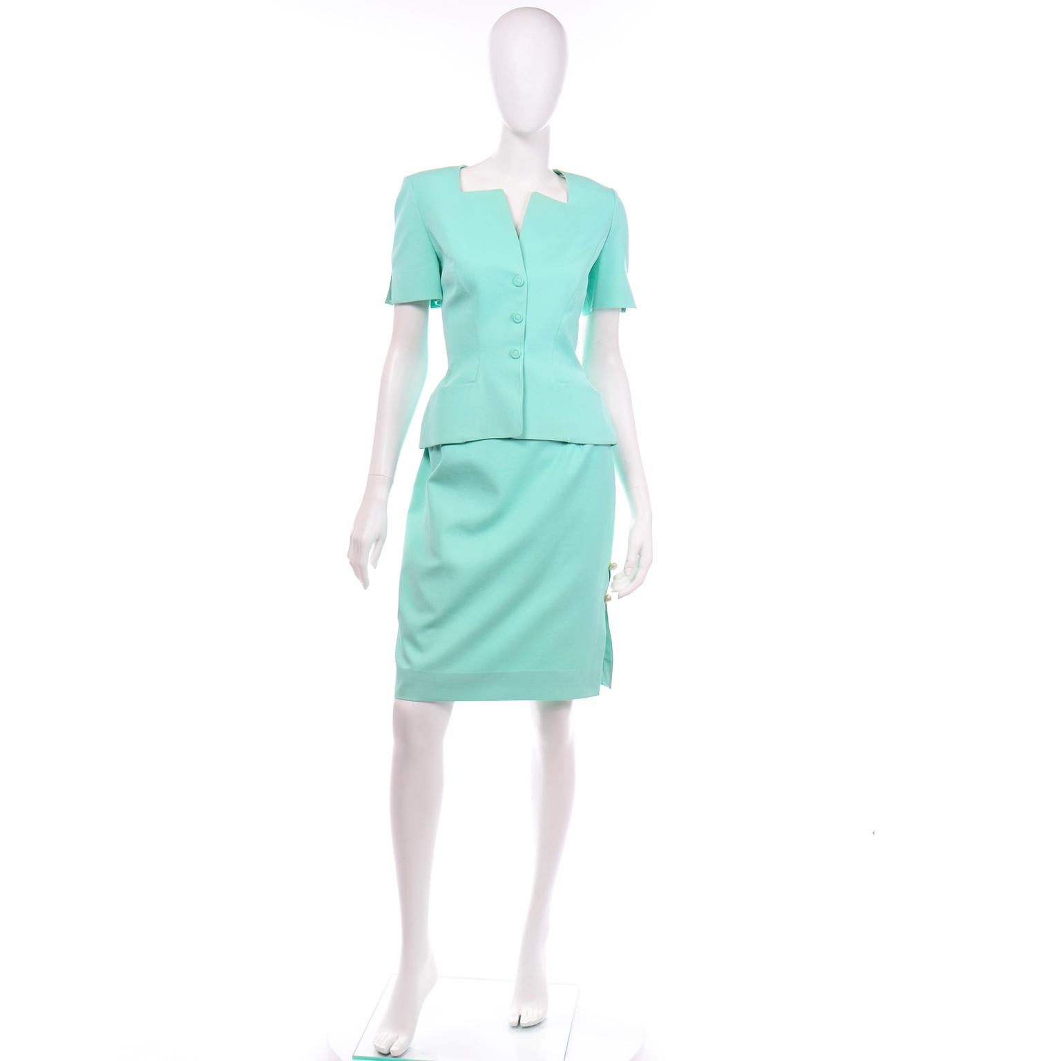 This vintage Thierry Mugler textured short sleeve skirt suit is in such a beautiful shade of mint green!  The jacket top is short sleeve and has shoulder pads for structure and a slight  peplum. This suit has the iconic Mugler silhouette with the